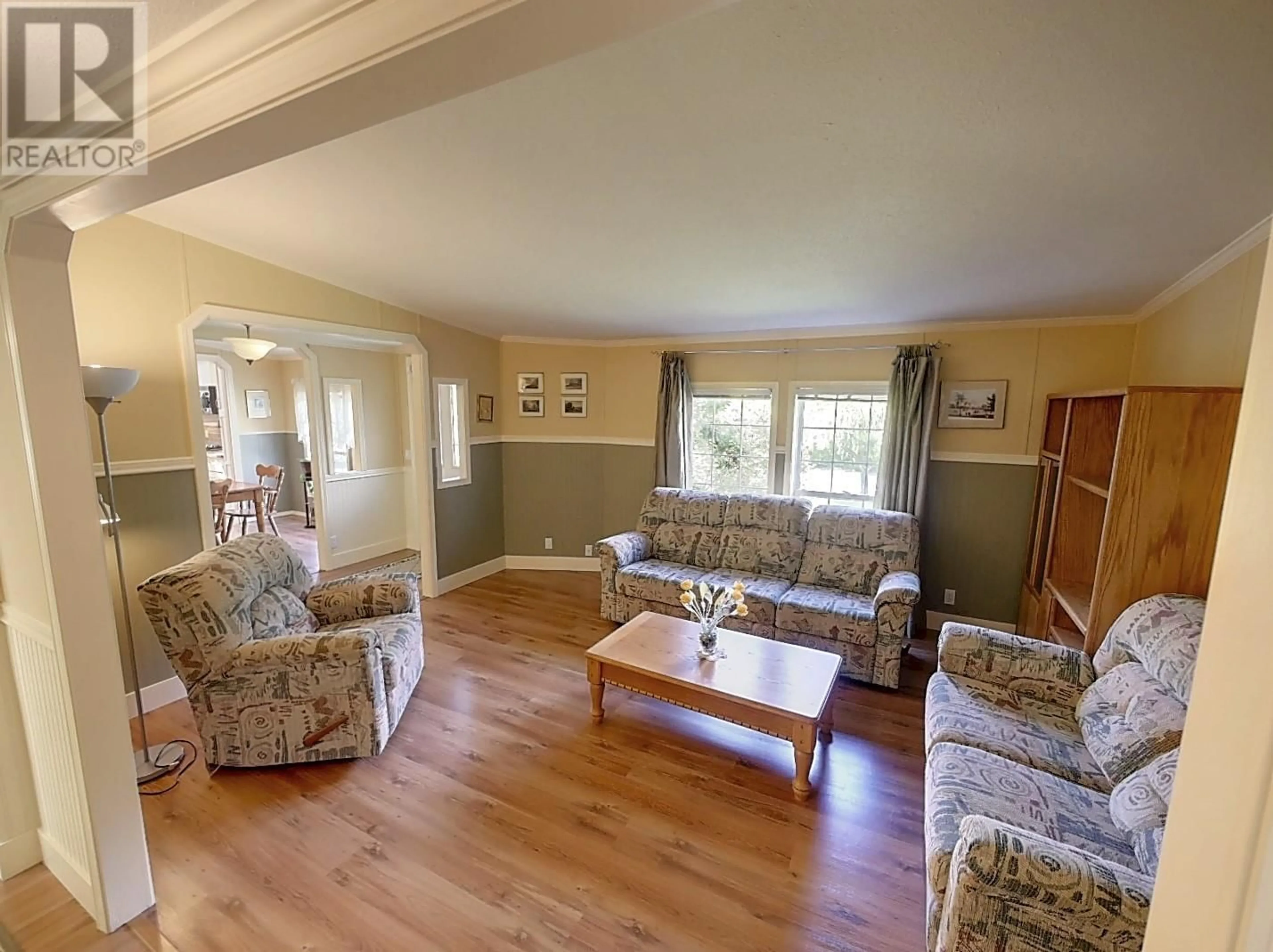 Living room with furniture, wood/laminate floor for 82 FRANSON ROAD, Christina Lake British Columbia V0H1E2