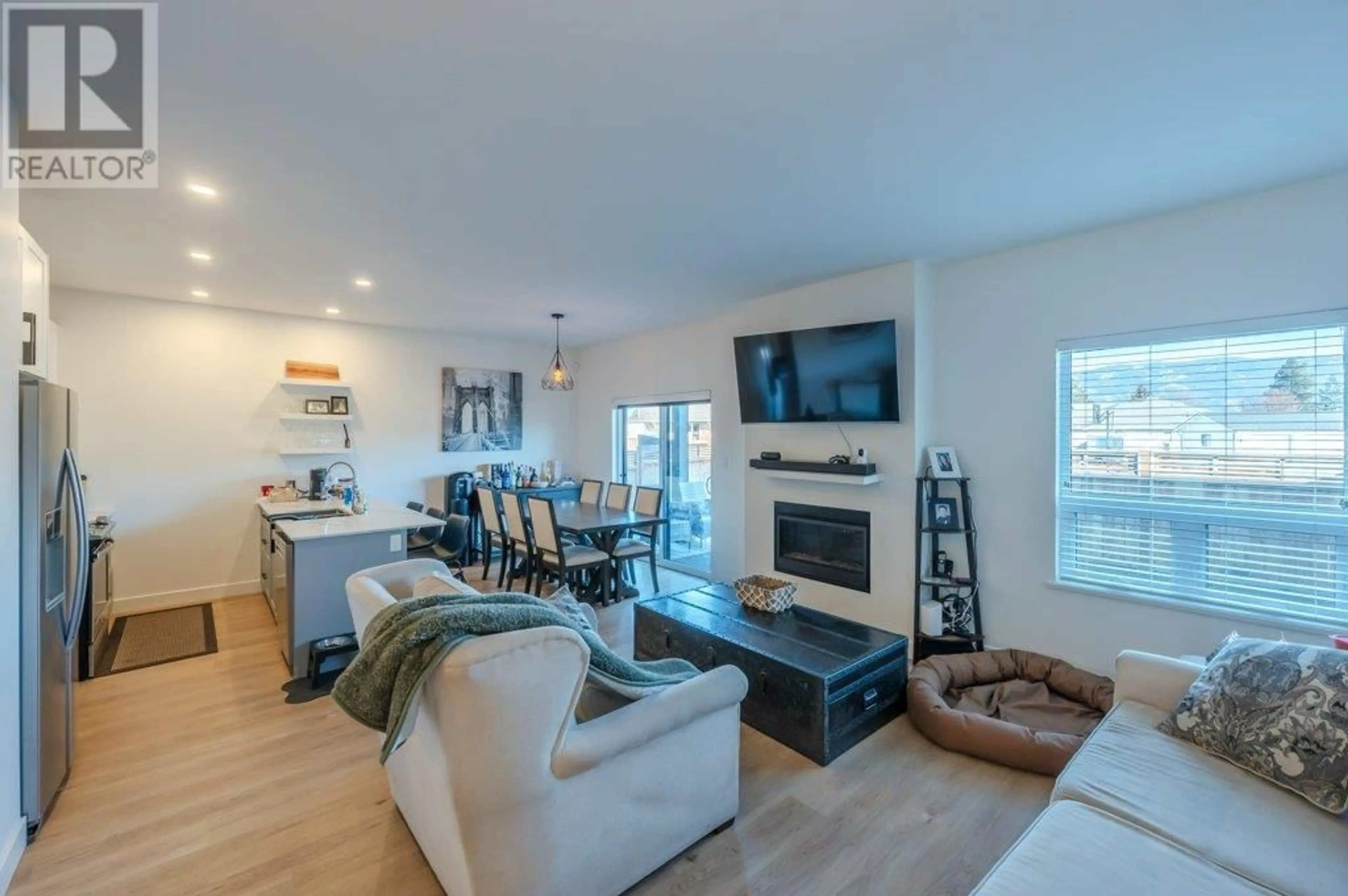 Living room with furniture, wood/laminate floor for 102 - 5011 TOWGOOD PLACE, Summerland British Columbia V0H1Z9
