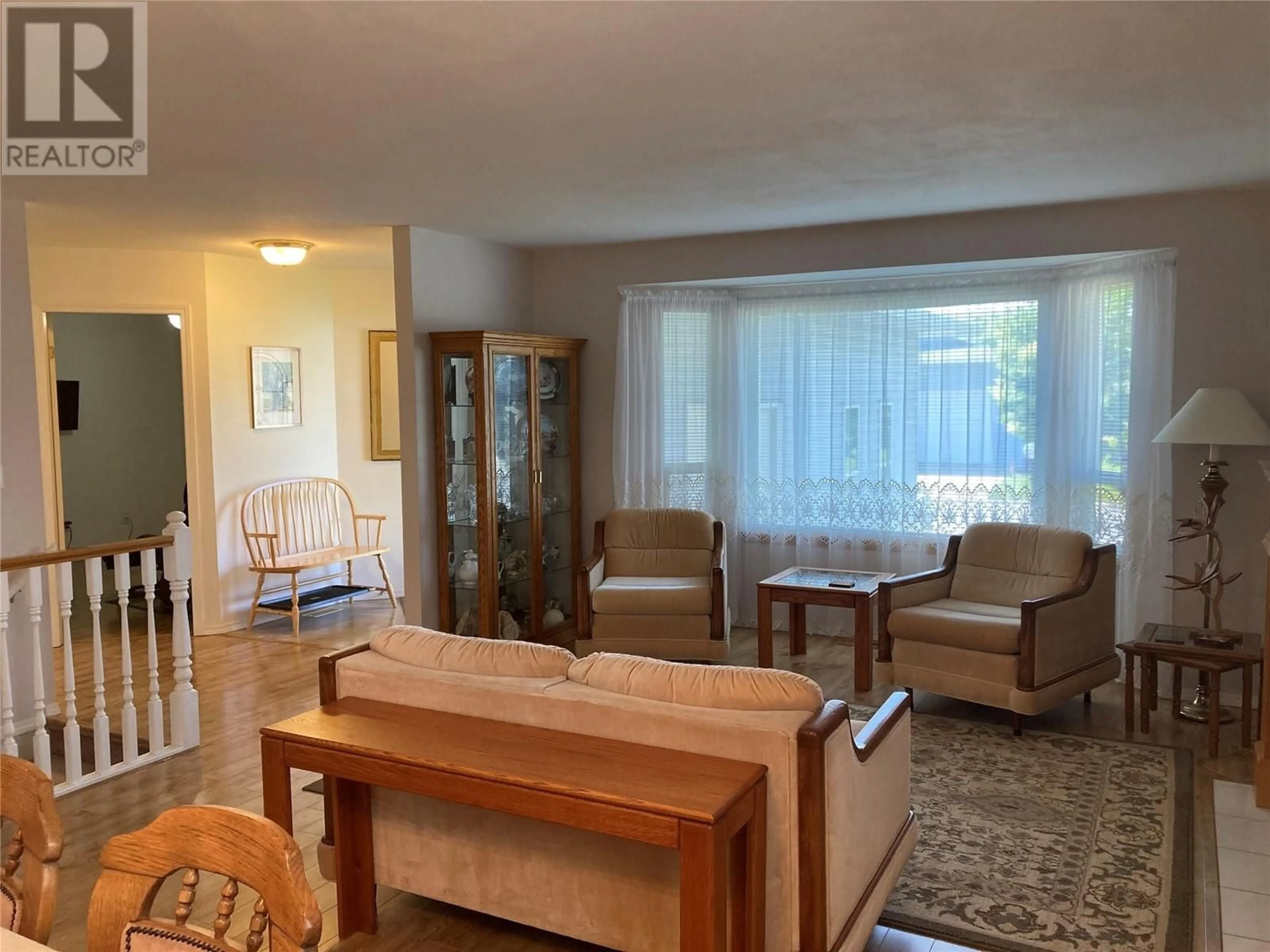 Living room with furniture, wood/laminate floor for 13 - 2655 WESTSYDE ROAD, Kamloops British Columbia V2B7C7