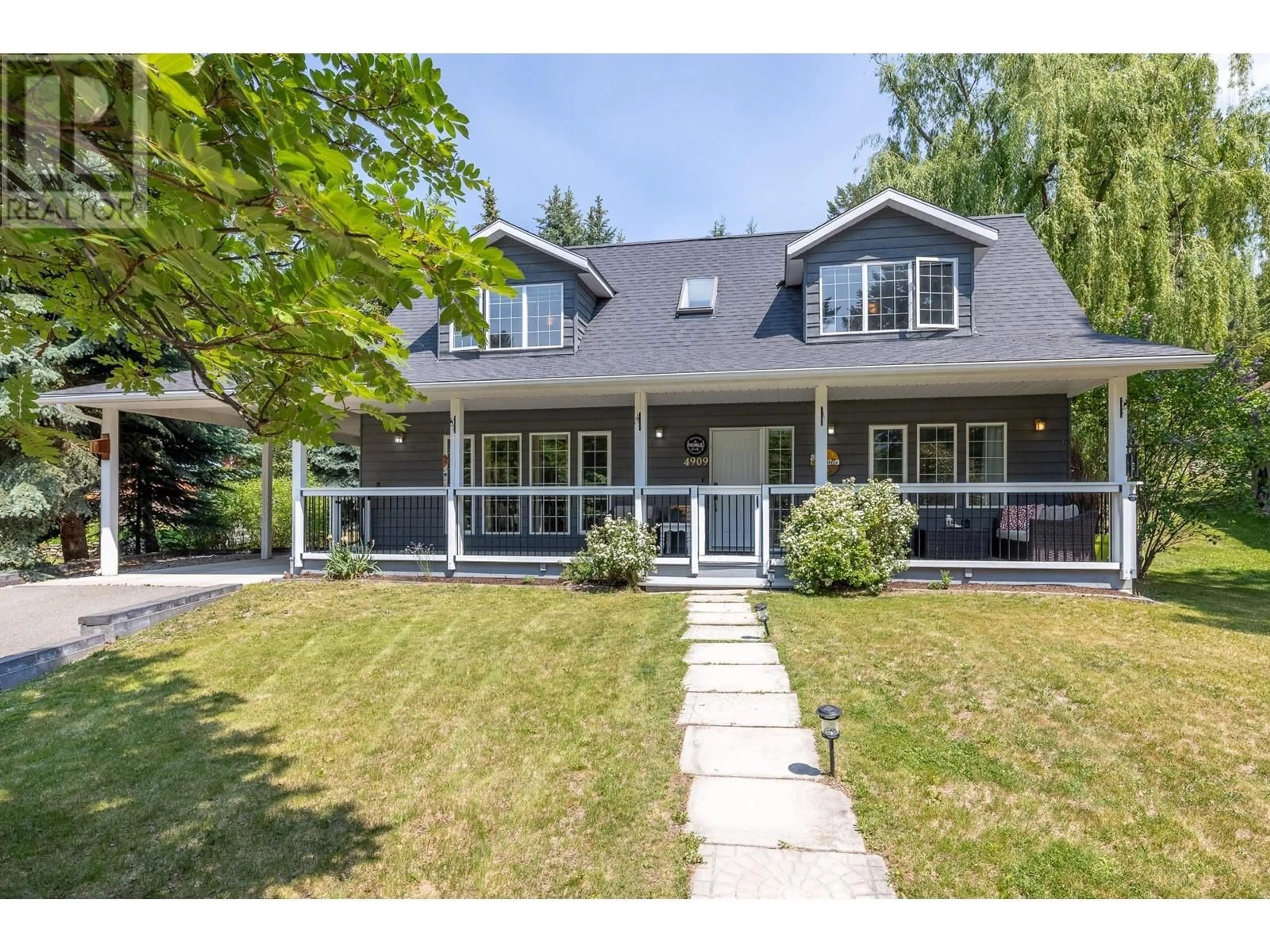 Home with vinyl exterior material, street for 4909 MEADOWS CRESCENT, Fairmont Hot Springs British Columbia V0B1L0