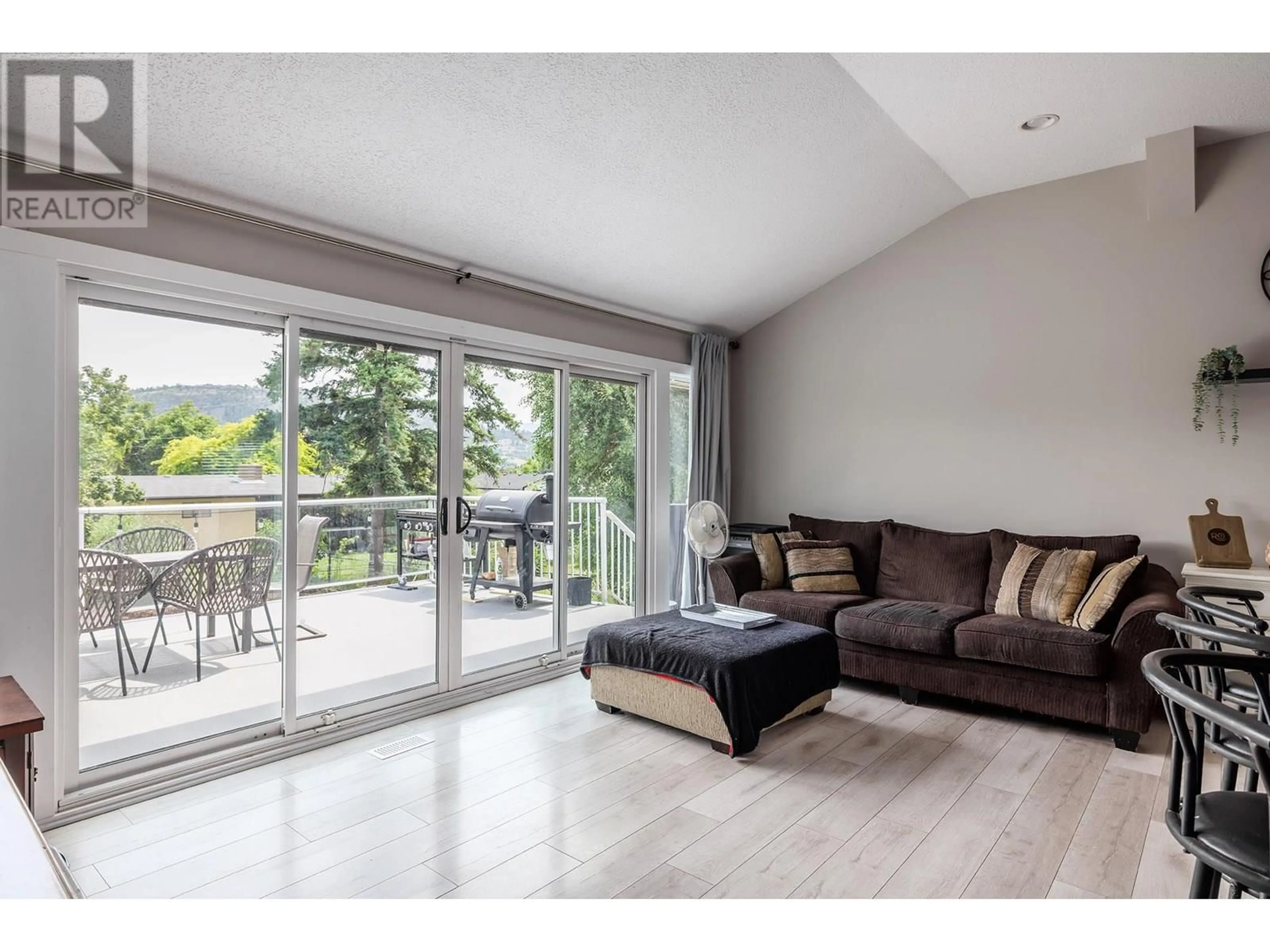 Living room with furniture, wood/laminate floor for 333 MOUBRAY ROAD, Kelowna British Columbia V1V1R5