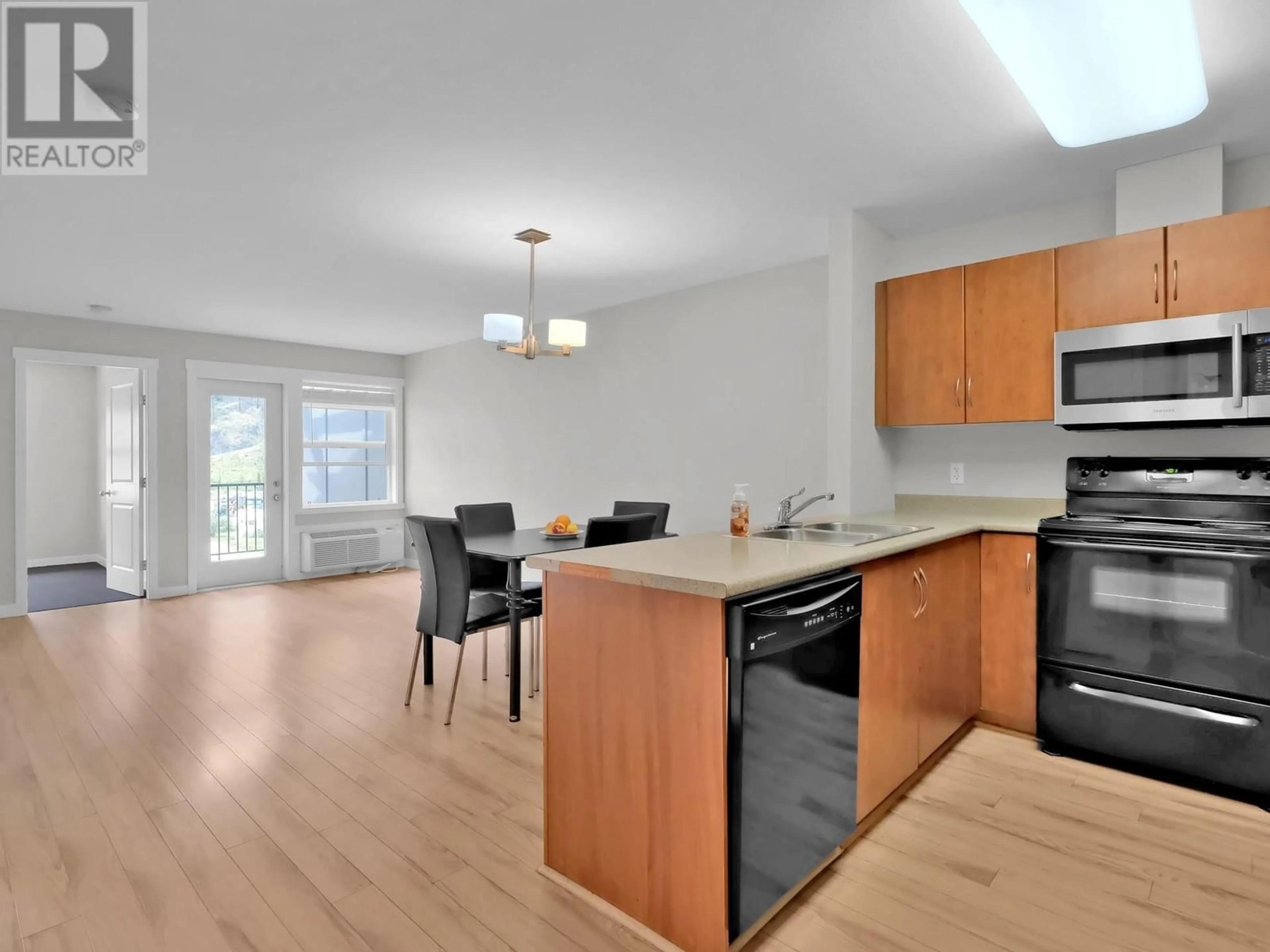 Open concept kitchen, wood/laminate floor for 302 - 1479 GLENMORE ROAD NORTH, Kelowna British Columbia V1V2C5