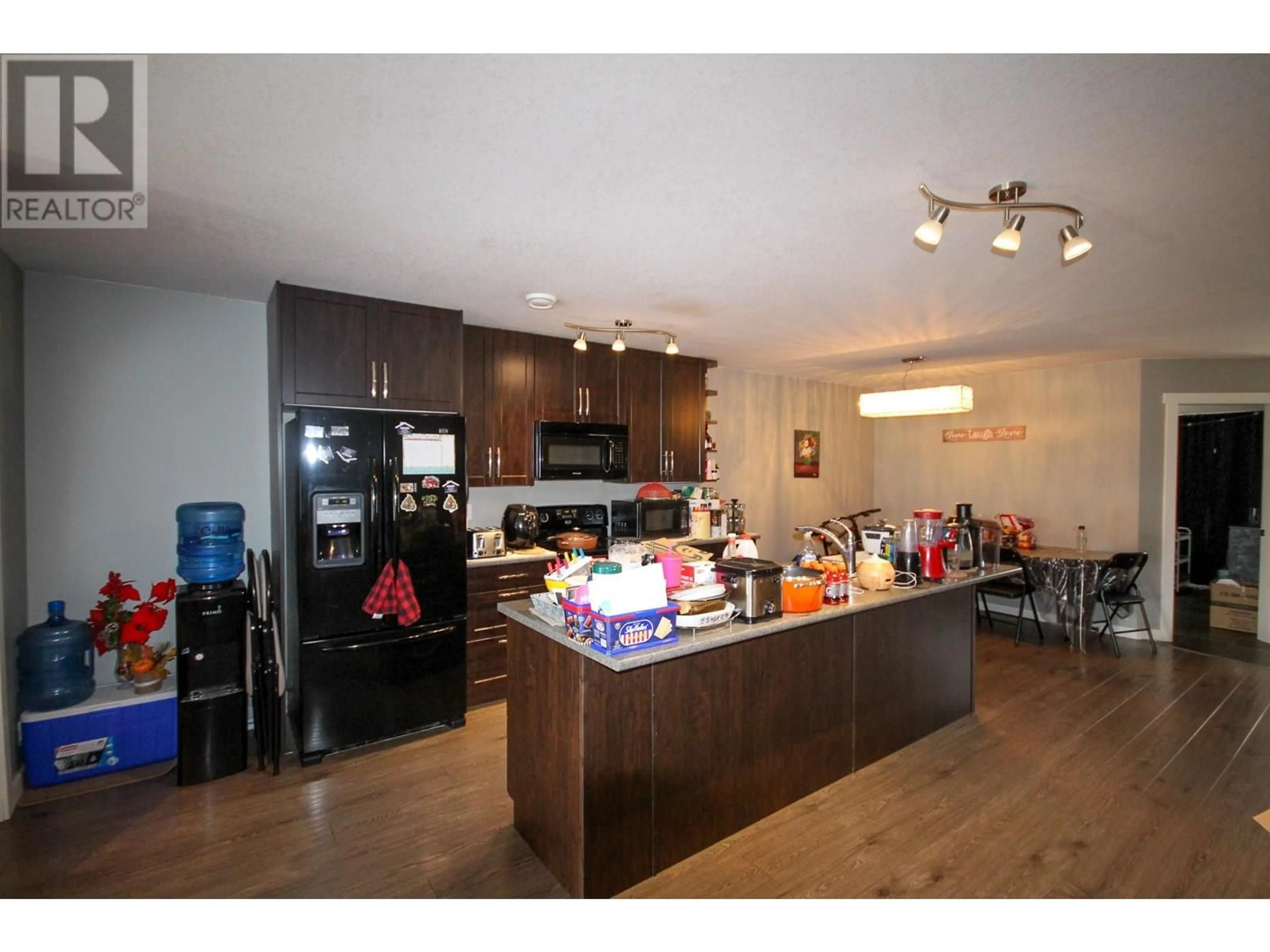 Open concept kitchen, wood/laminate floor for 8215 18 STREET, Dawson Creek British Columbia V1G4E2