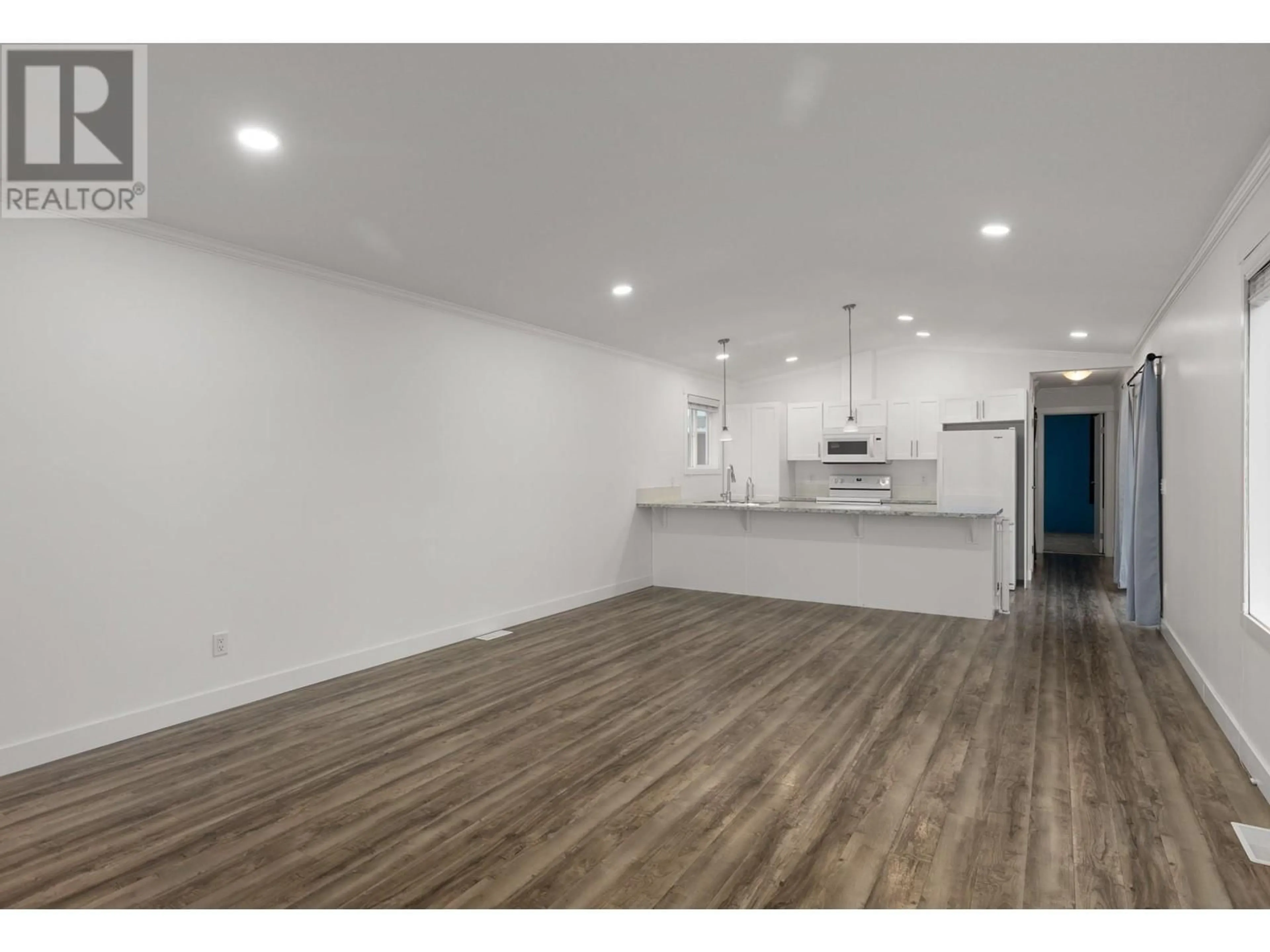 Open concept kitchen, wood/laminate floor for 148 - 9020 JIM BAILEY ROAD, Kelowna British Columbia V4V1E5