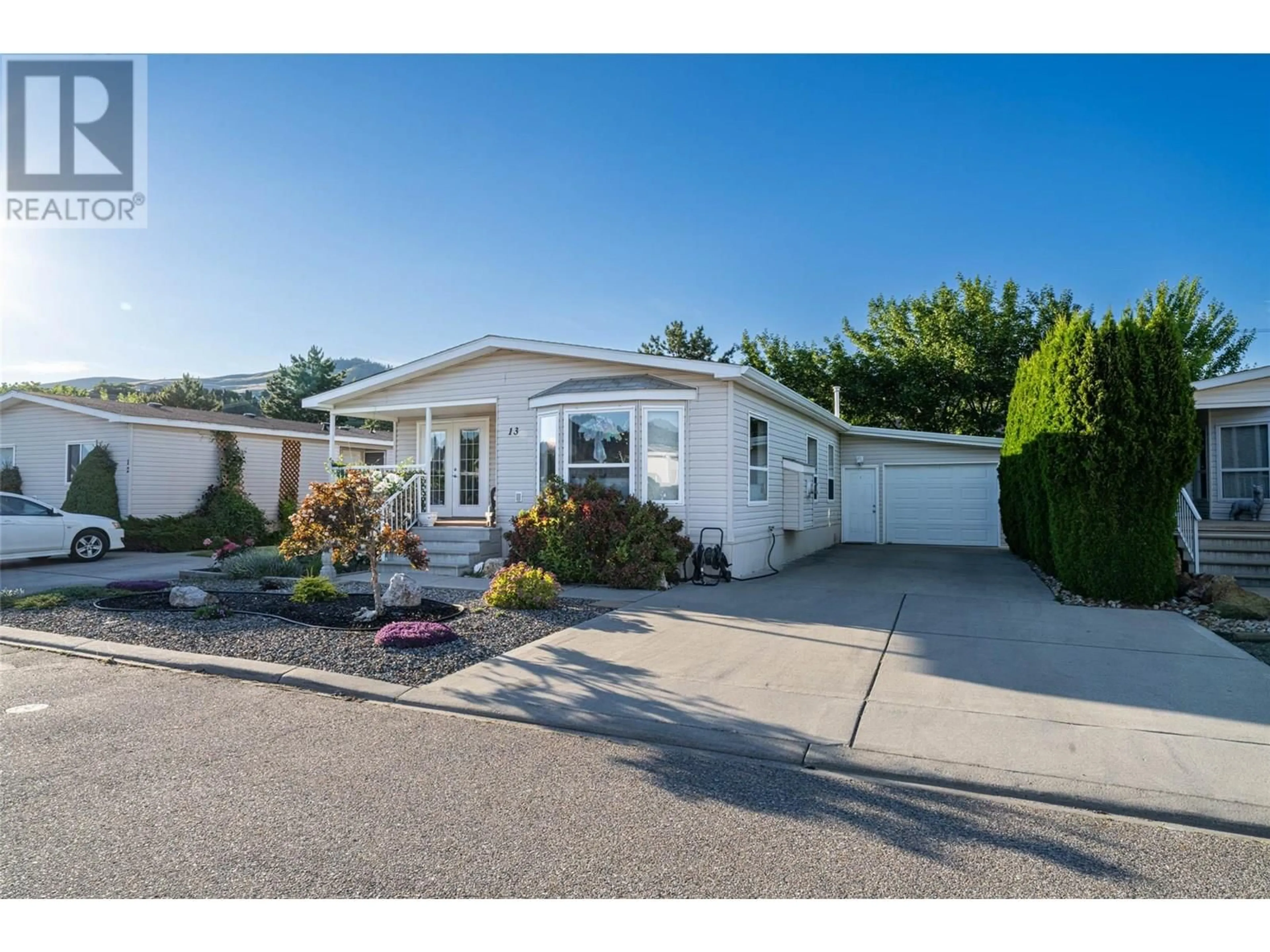 Home with vinyl exterior material, street for 13 - 6688 TRONSON ROAD, Vernon British Columbia V1H1R9