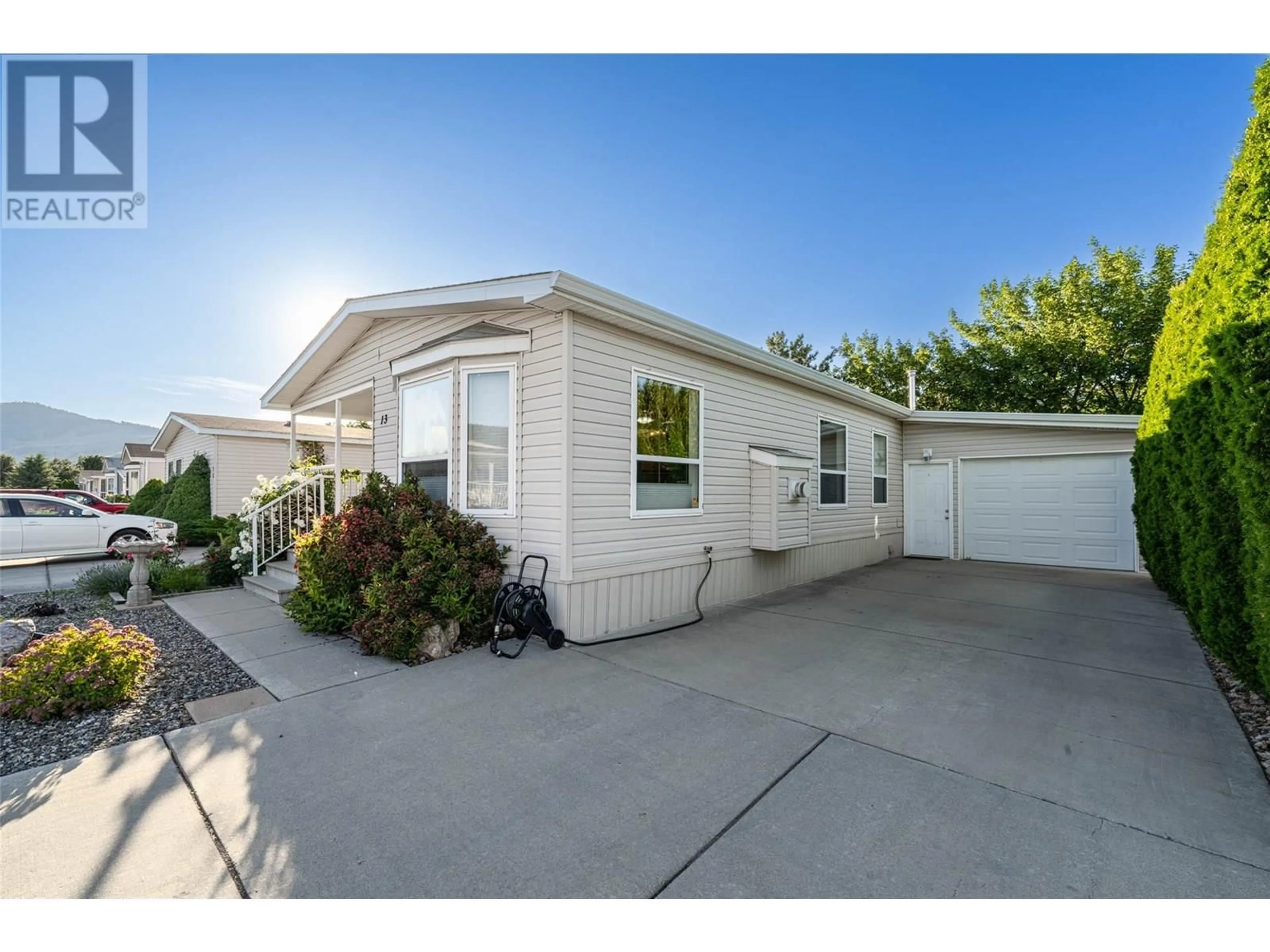 Home with vinyl exterior material, street for 13 - 6688 TRONSON ROAD, Vernon British Columbia V1H1R9