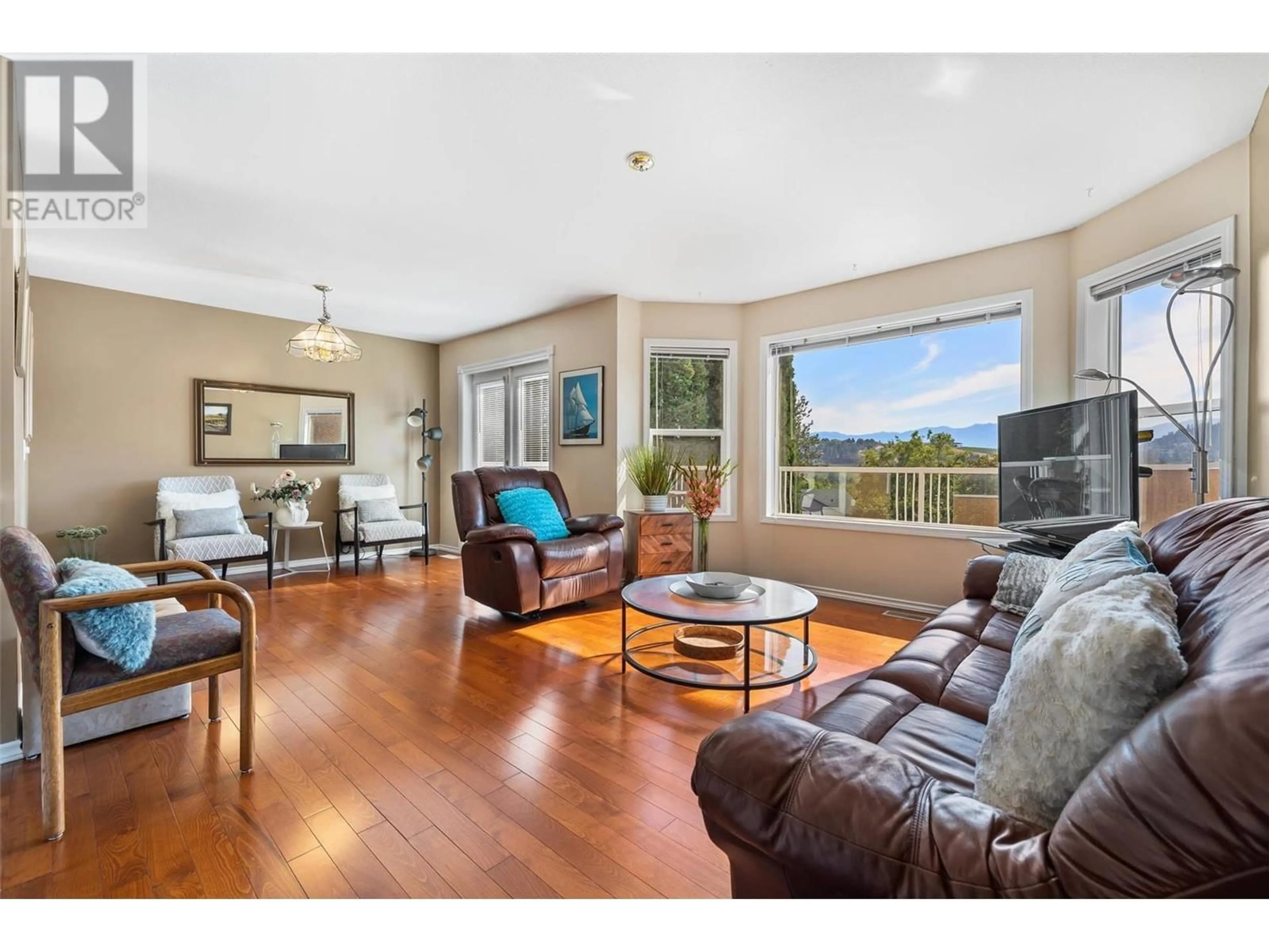Living room with furniture, wood/laminate floor for 1056 CALEDONIA WAY, West Kelowna British Columbia V1Z3N7