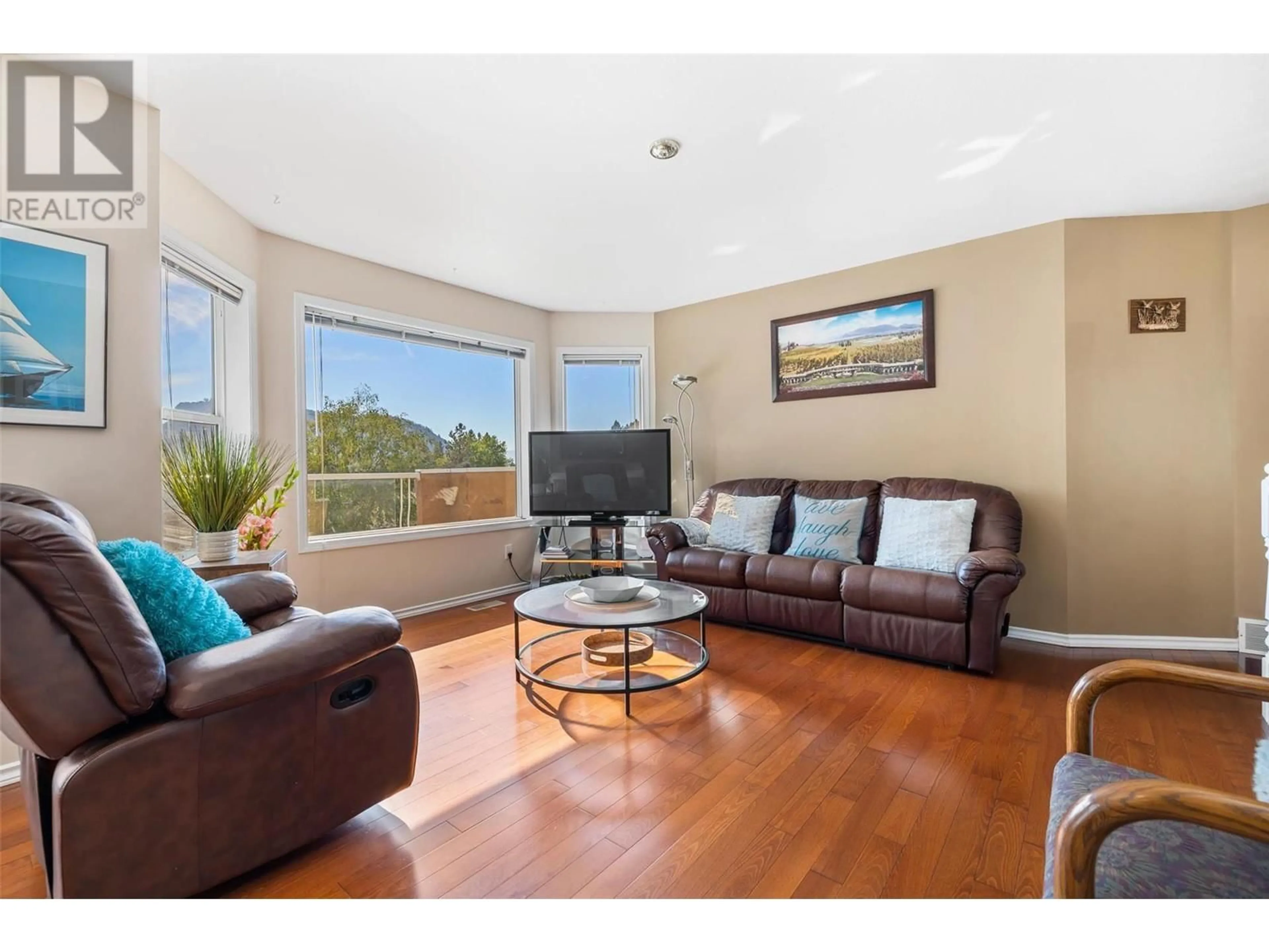 Living room with furniture, wood/laminate floor for 1056 CALEDONIA WAY, West Kelowna British Columbia V1Z3N7
