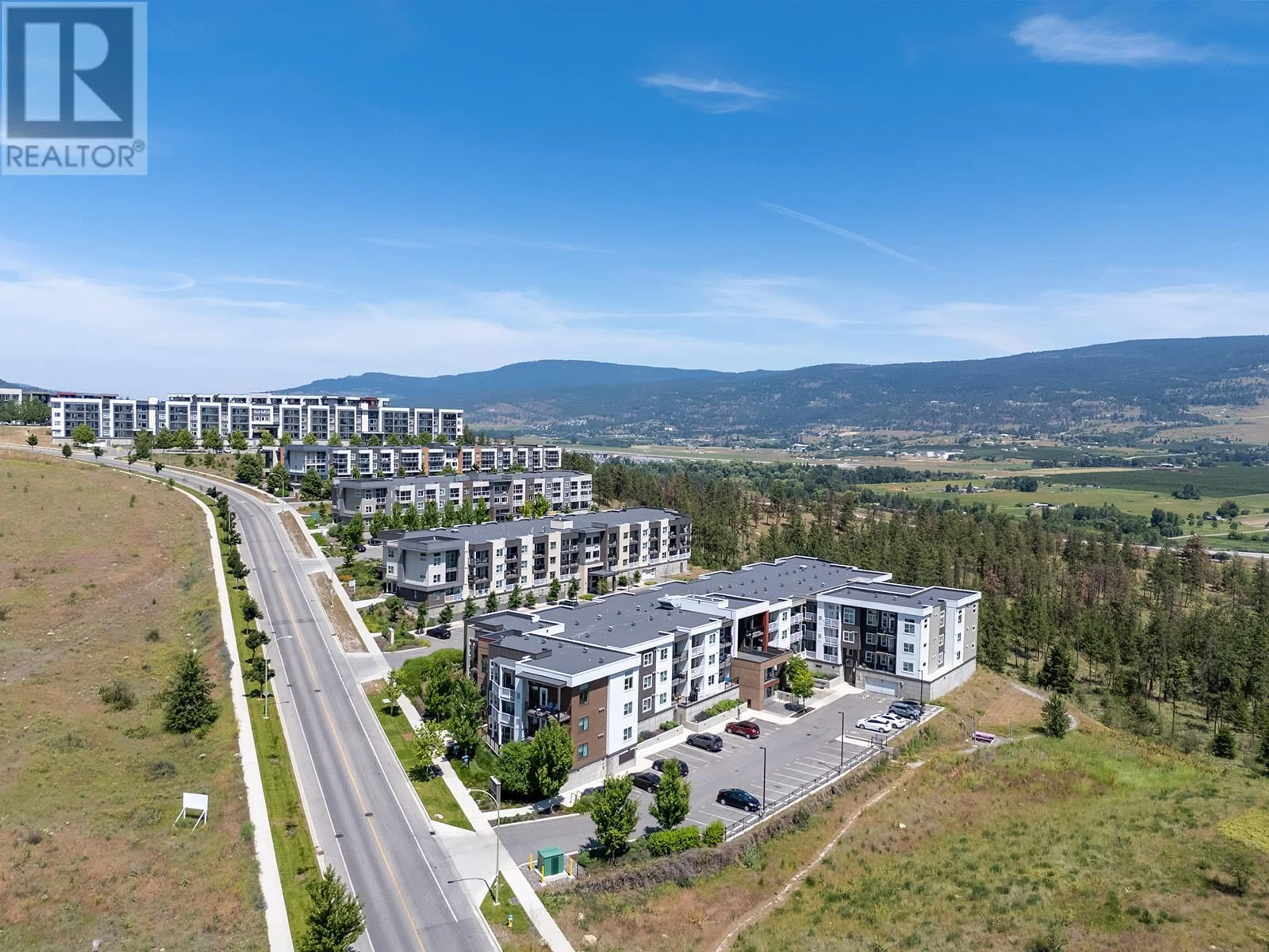 A pic from outside/outdoor area/front of a property/back of a property/a pic from drone, mountain view for 203 - 625 ACADEMY WAY, Kelowna British Columbia V1V0E3