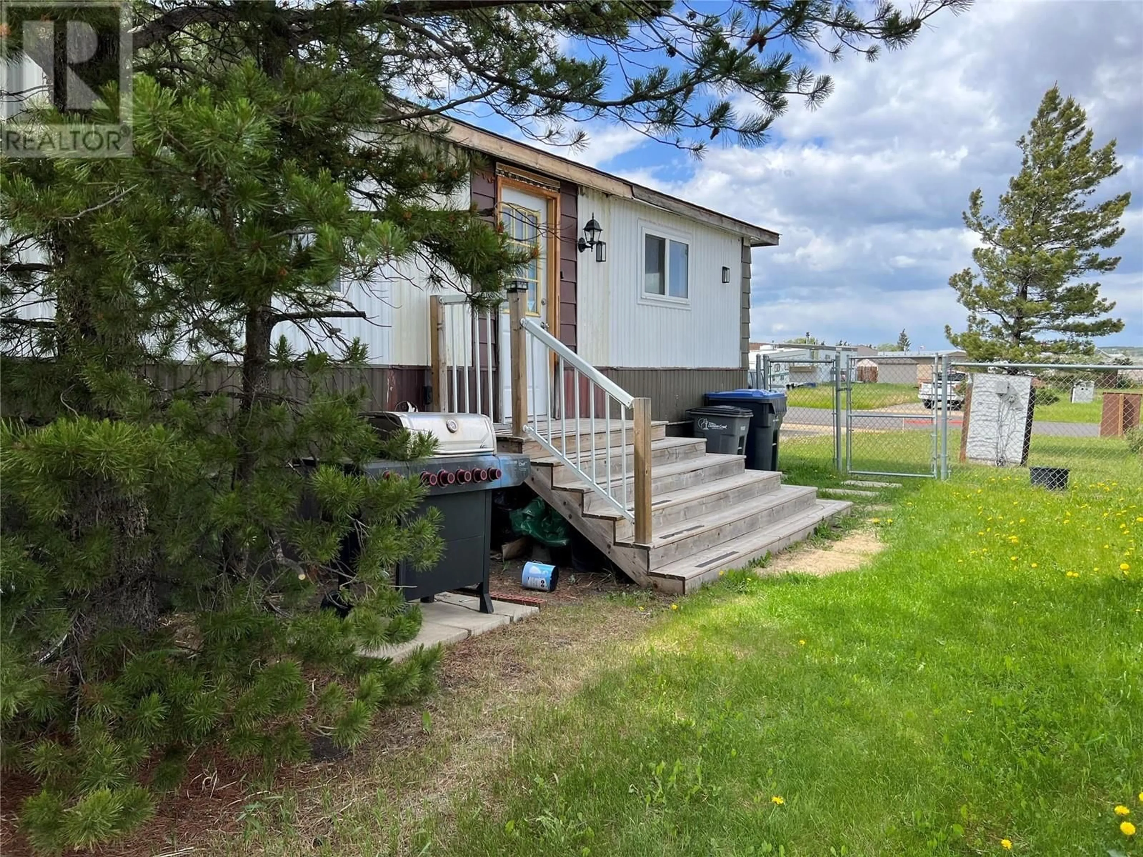 A pic from outside/outdoor area/front of a property/back of a property/a pic from drone, water/lake/river/ocean view for 80 - 1201 118 AVENUE, Dawson Creek British Columbia V1G4L2