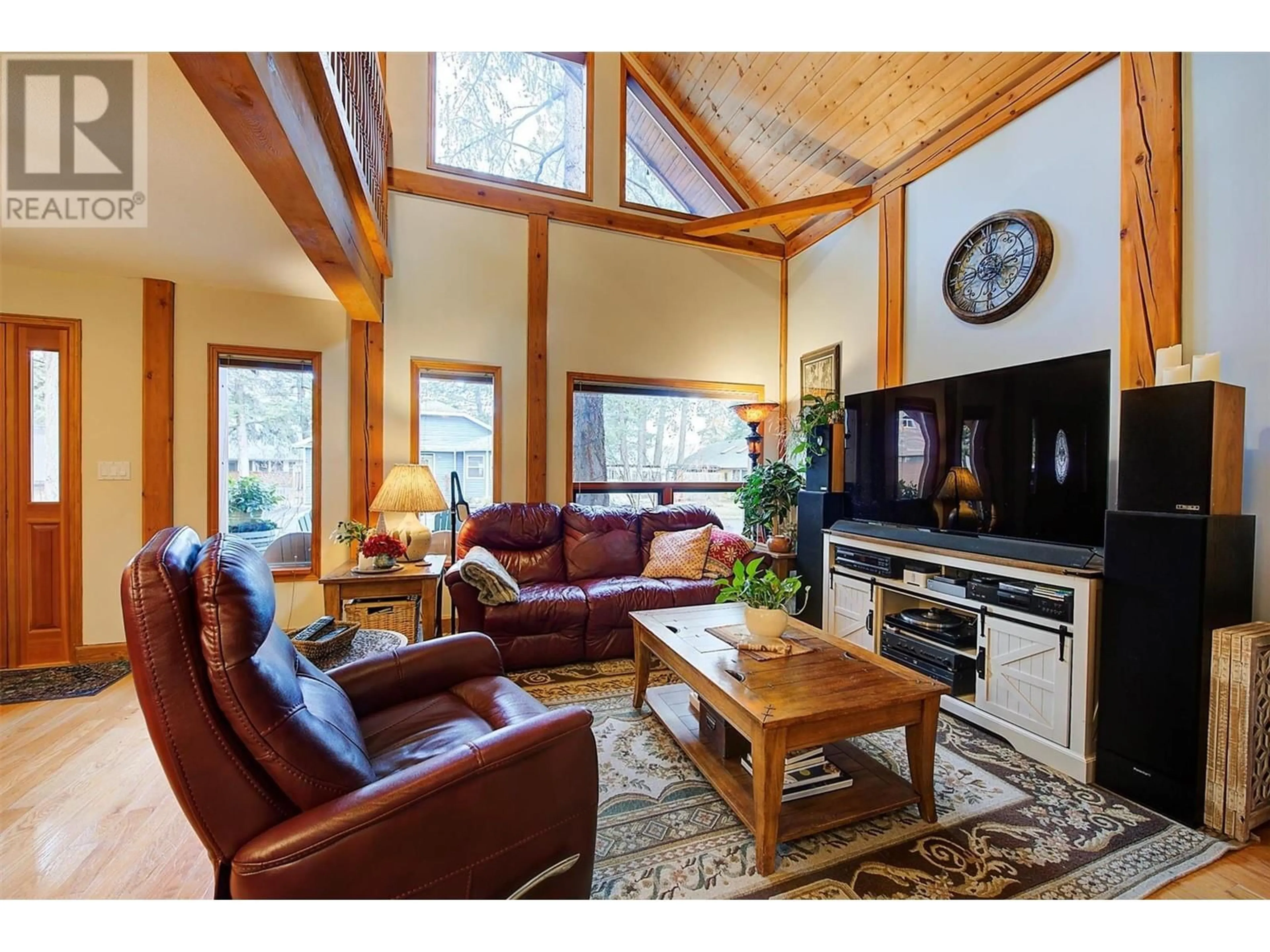 Living room with furniture, wood/laminate floor for 346 HUMMINGBIRD AVENUE, Vernon British Columbia V1H2A1