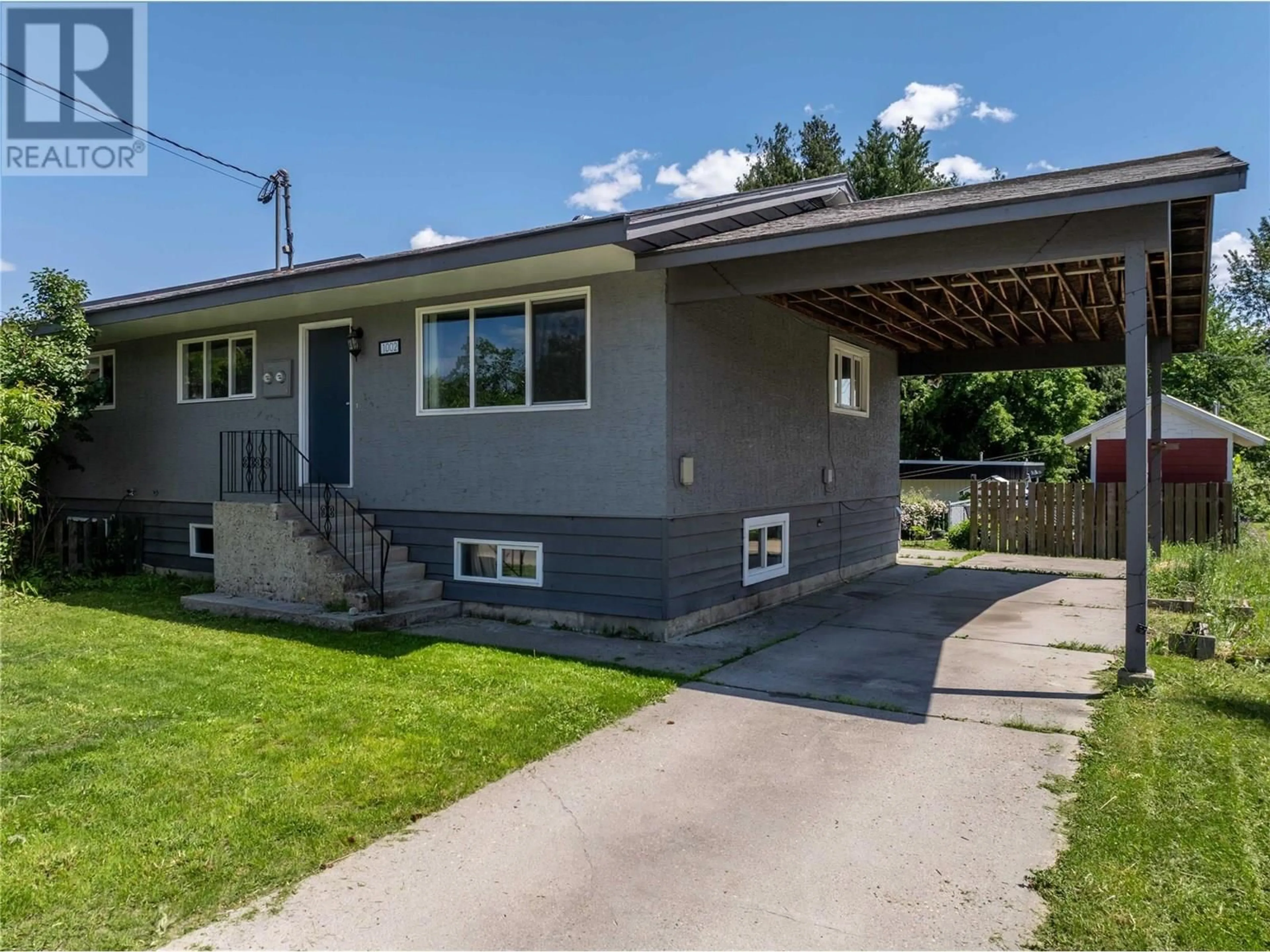 Home with vinyl exterior material, street for 1002 VICTORIA ROAD, Revelstoke British Columbia V0E2S0