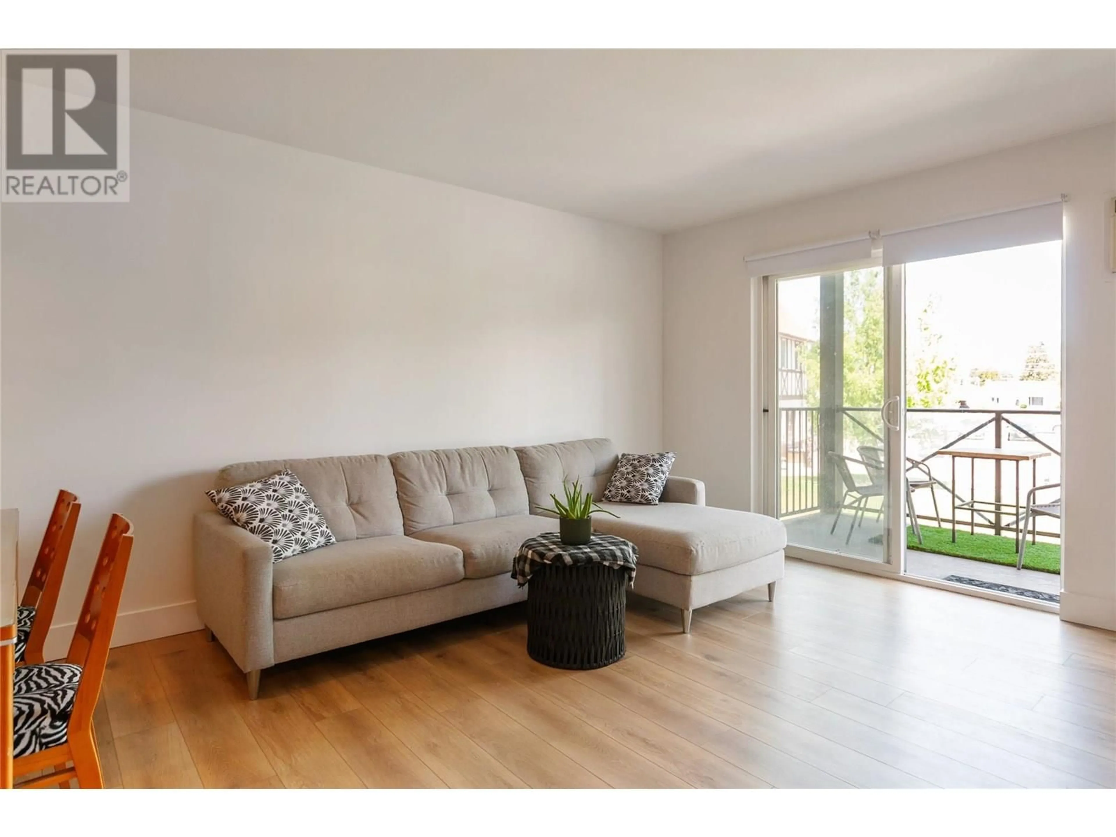 Living room with furniture, wood/laminate floor for 206 - 246 HASTINGS AVENUE, Penticton British Columbia V2A2V6
