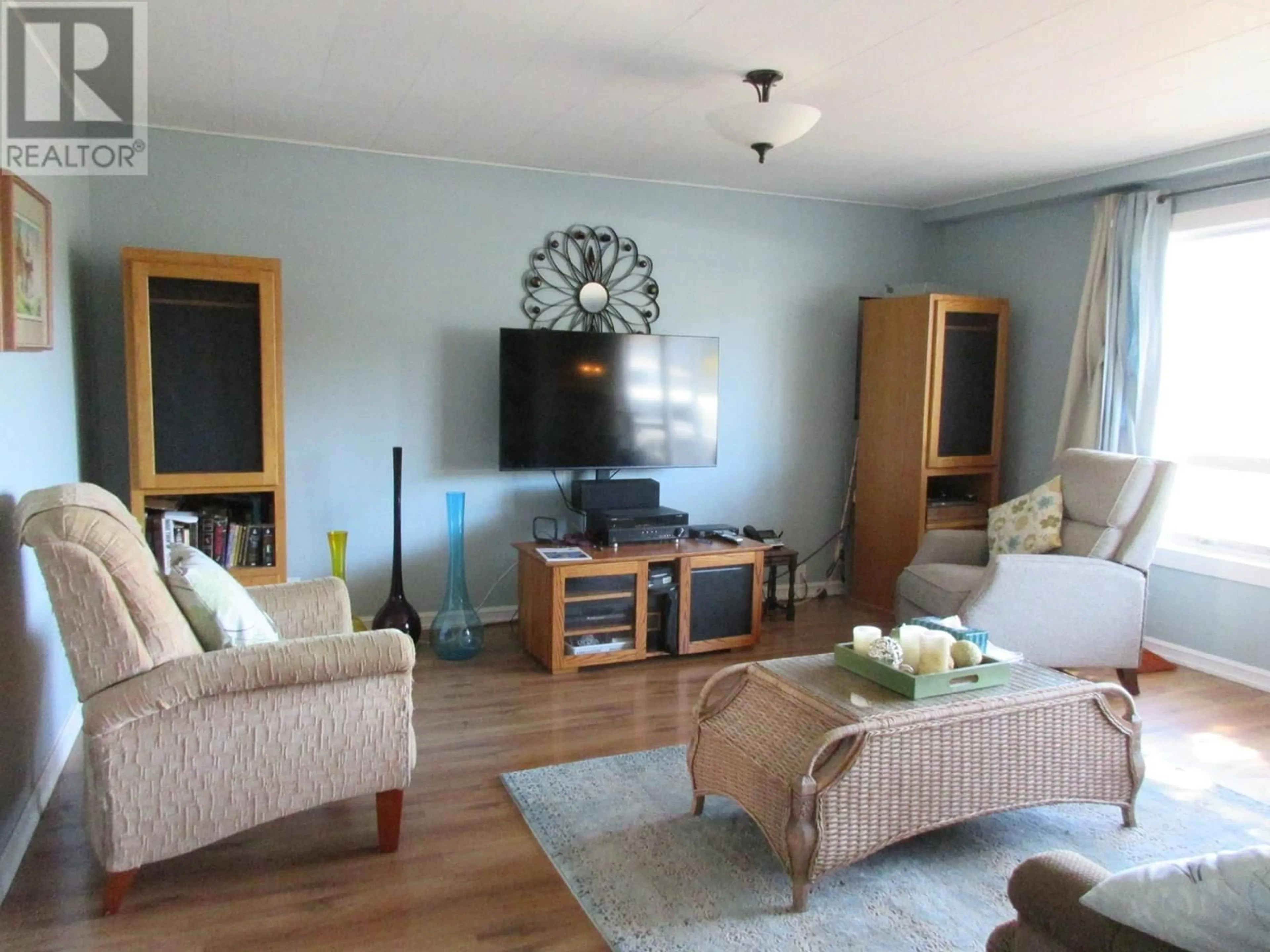Living room with furniture, wood/laminate floor for 2563 COUTLEE AVENUE, Merritt British Columbia V1K1B8