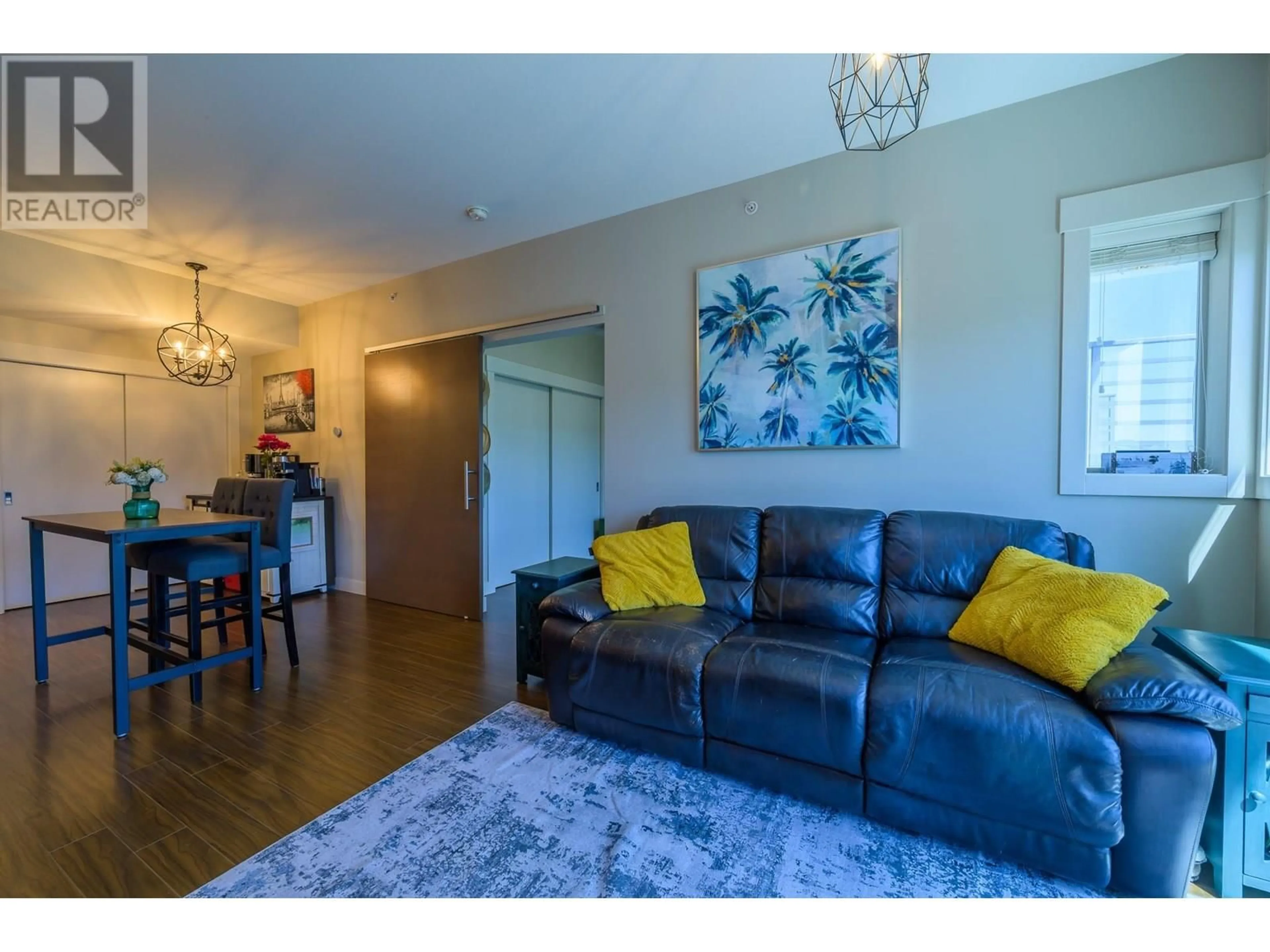 Living room with furniture, wood/laminate floor for 3410 - 1040 TALASA WAY, Kamloops British Columbia V2H0C4