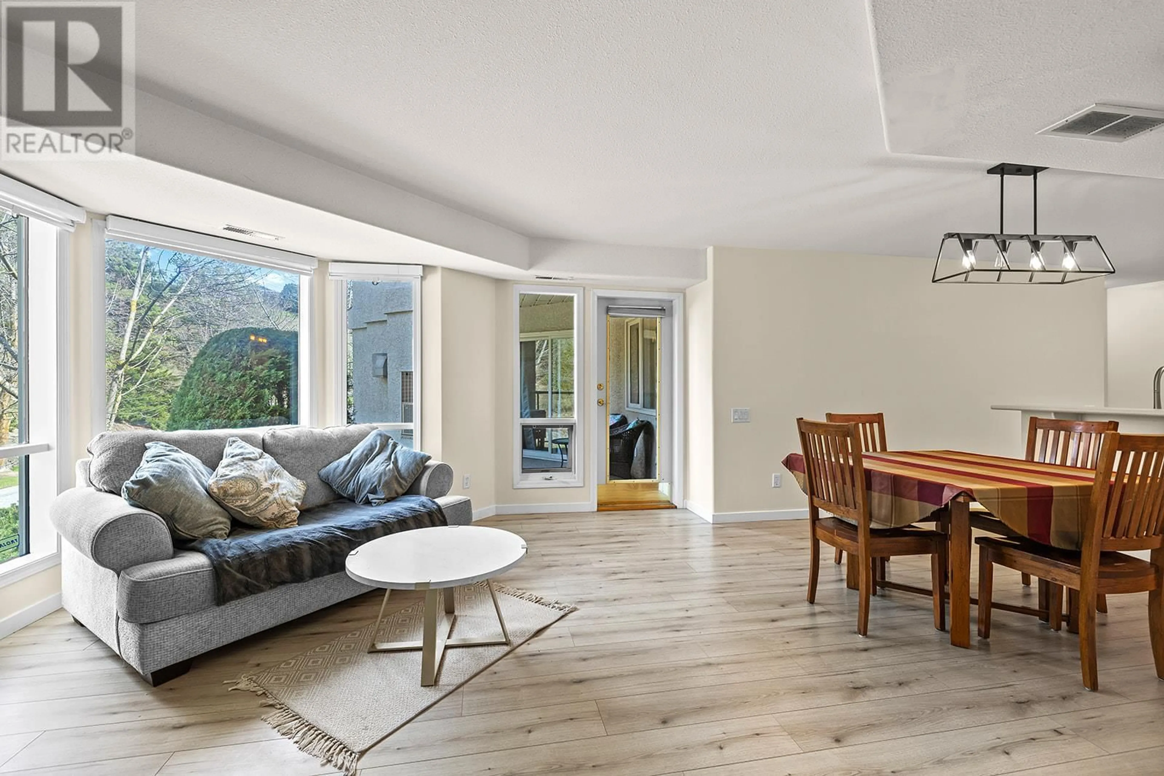 Living room with furniture, wood/laminate floor for 107 - 980 DILWORTH DRIVE, Kelowna British Columbia V1V1S6