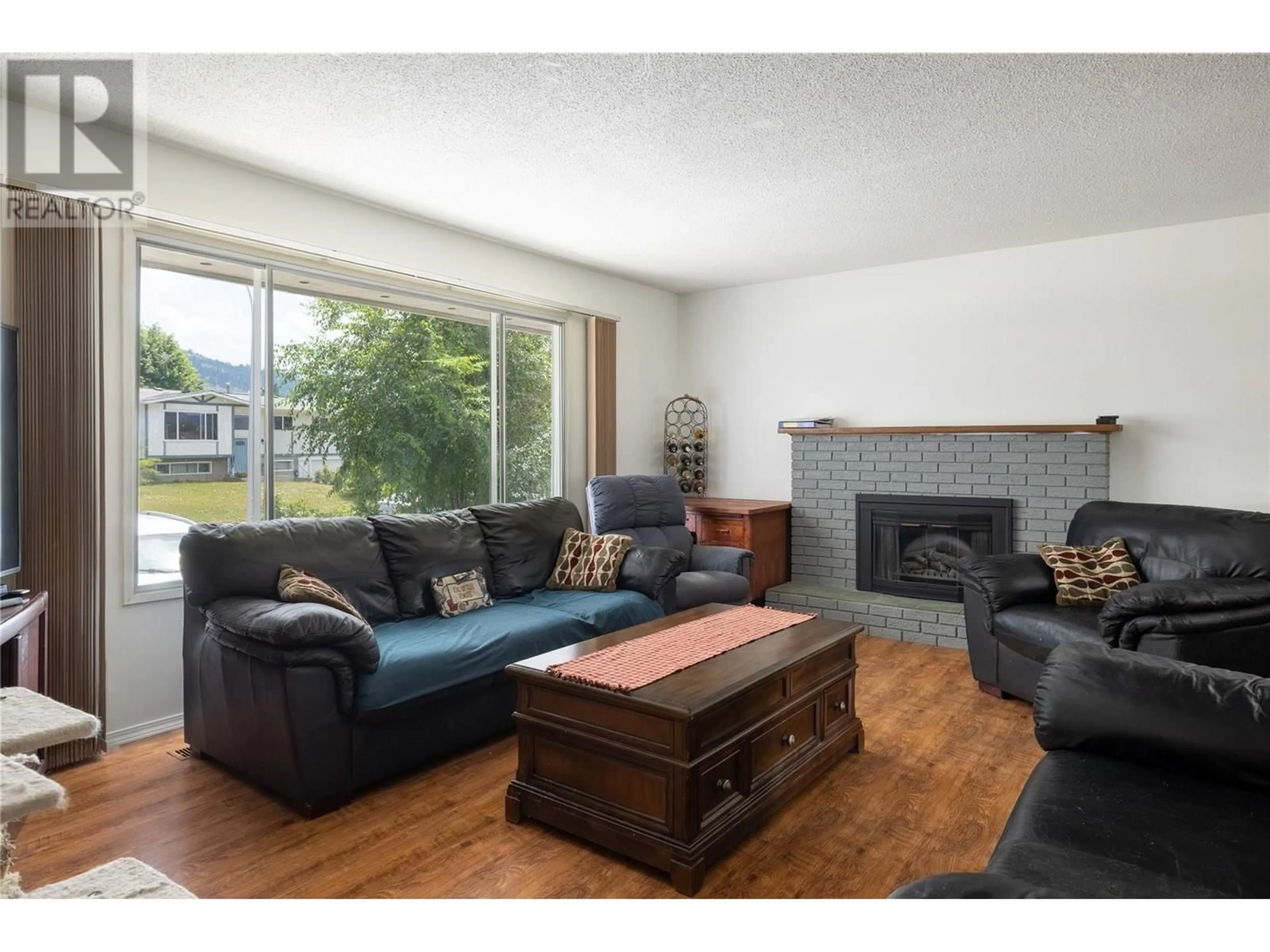 Living room with furniture, wood/laminate floor for 3102 13 STREET, Vernon British Columbia V1T4G4