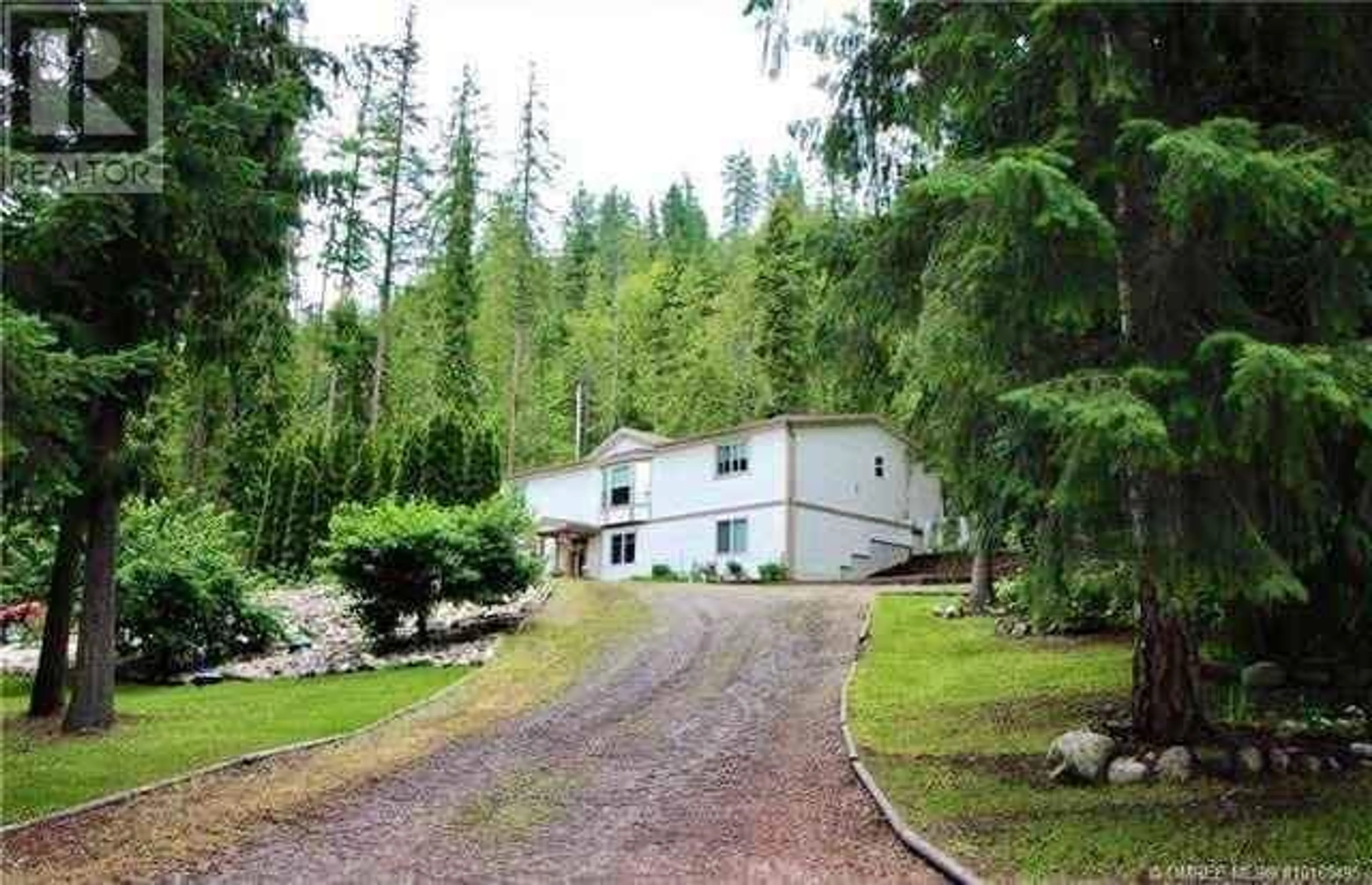 A pic from outside/outdoor area/front of a property/back of a property/a pic from drone, forest/trees view for 9000 HUMMINGBIRD DRIVE, Swansea Point British Columbia V0E2K2