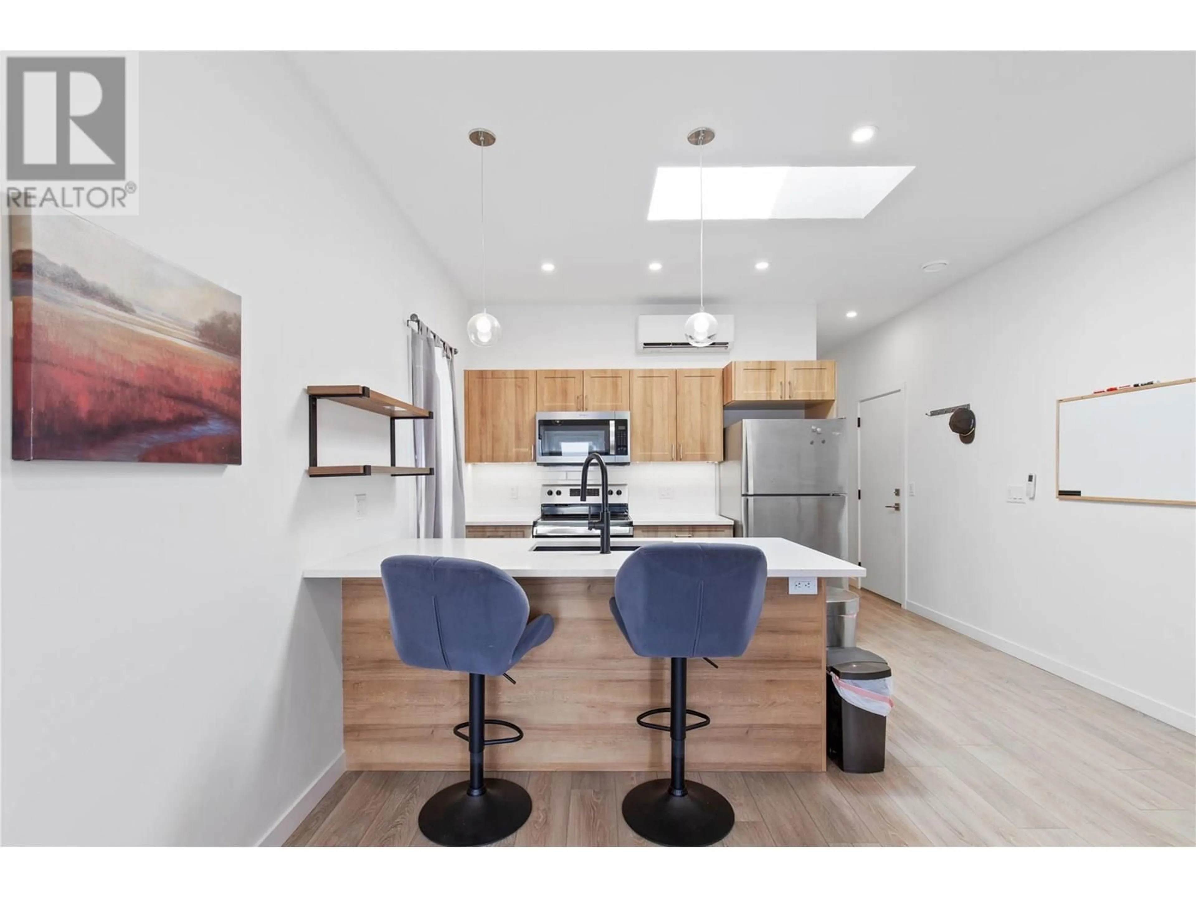 Open concept kitchen, wood/laminate floor for 107 - 8900 JIM BAILEY ROAD, Kelowna British Columbia V4V1E5