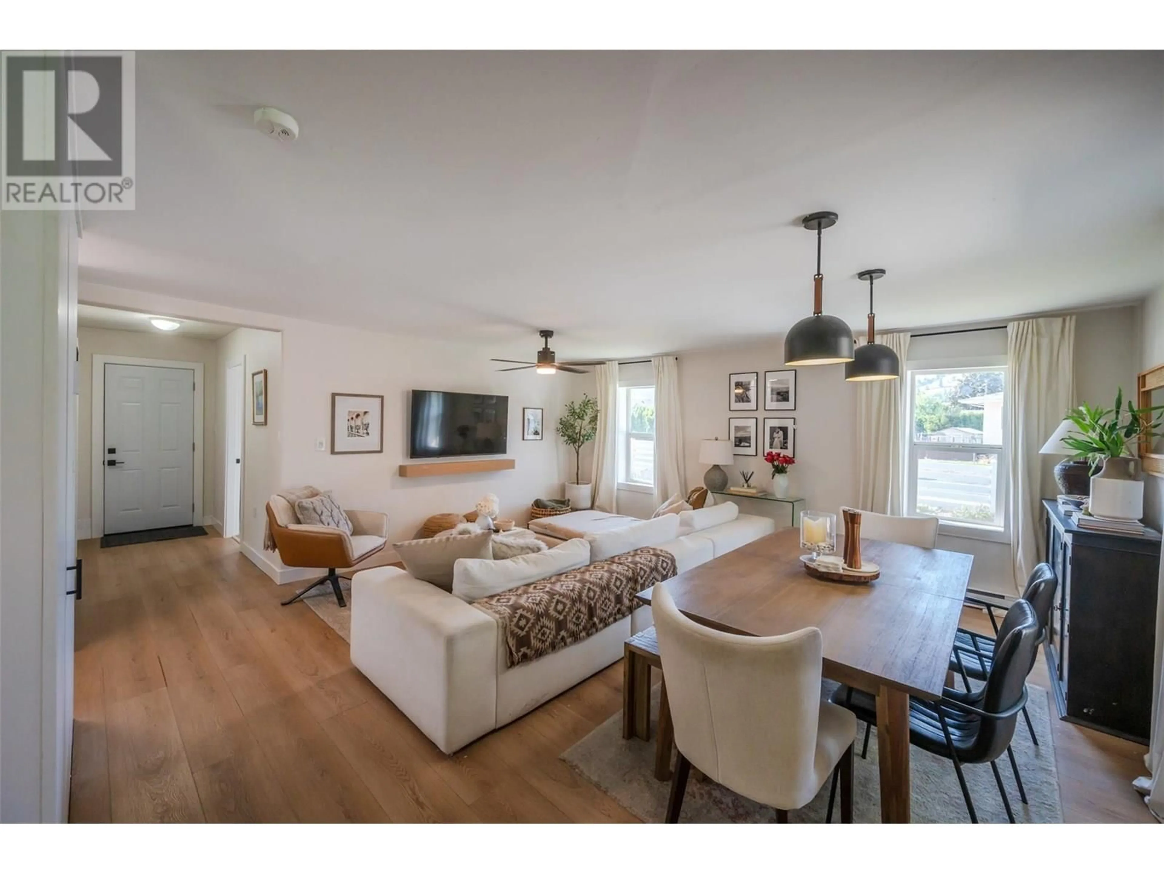 Living room with furniture, wood/laminate floor for 11716 PRAIRIE VALLEY ROAD, Summerland British Columbia V0H1Z8