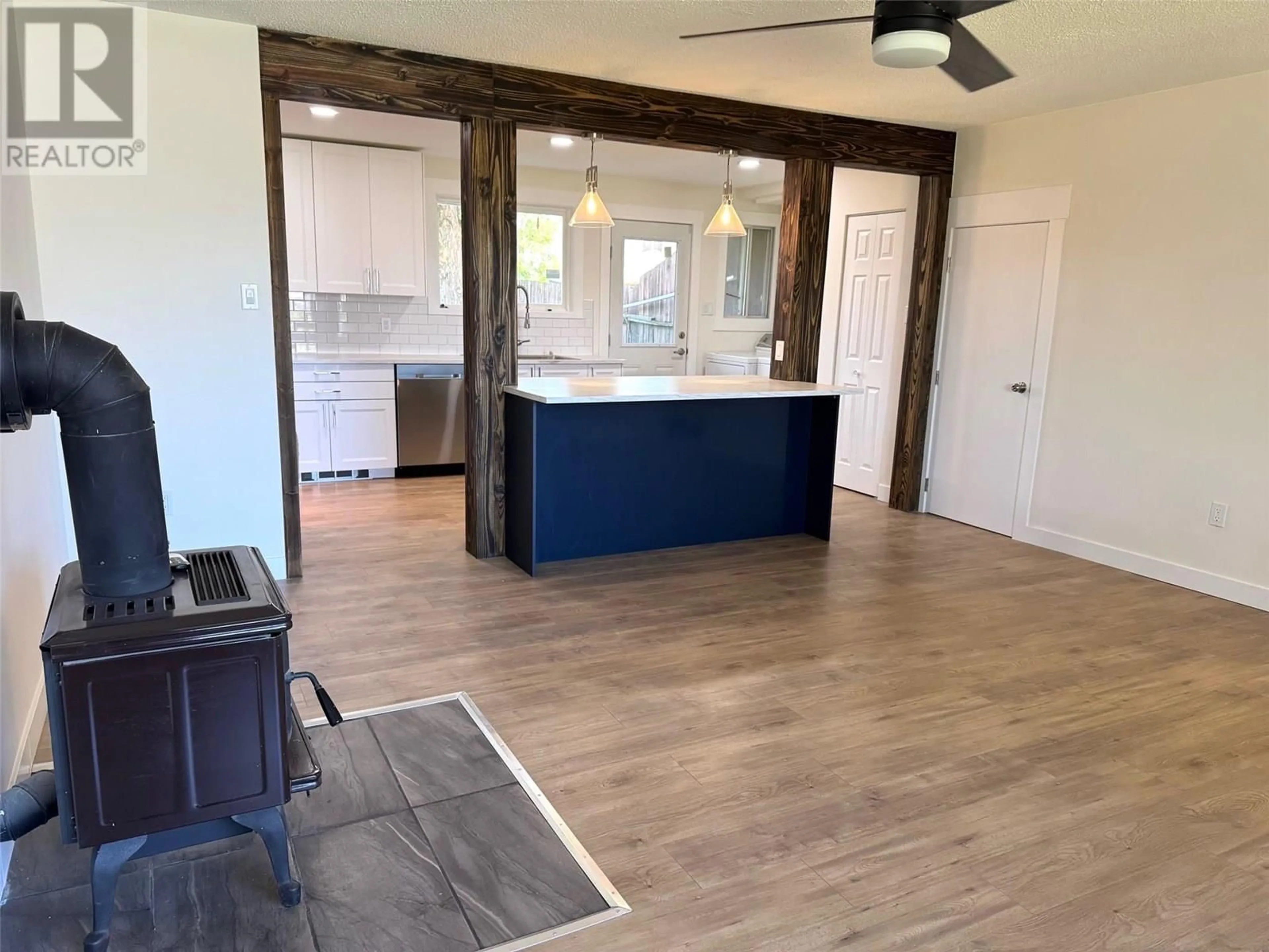 Open concept kitchen, wood/laminate floor for 1801 MENZIES STREET, Merritt British Columbia V1K1E4