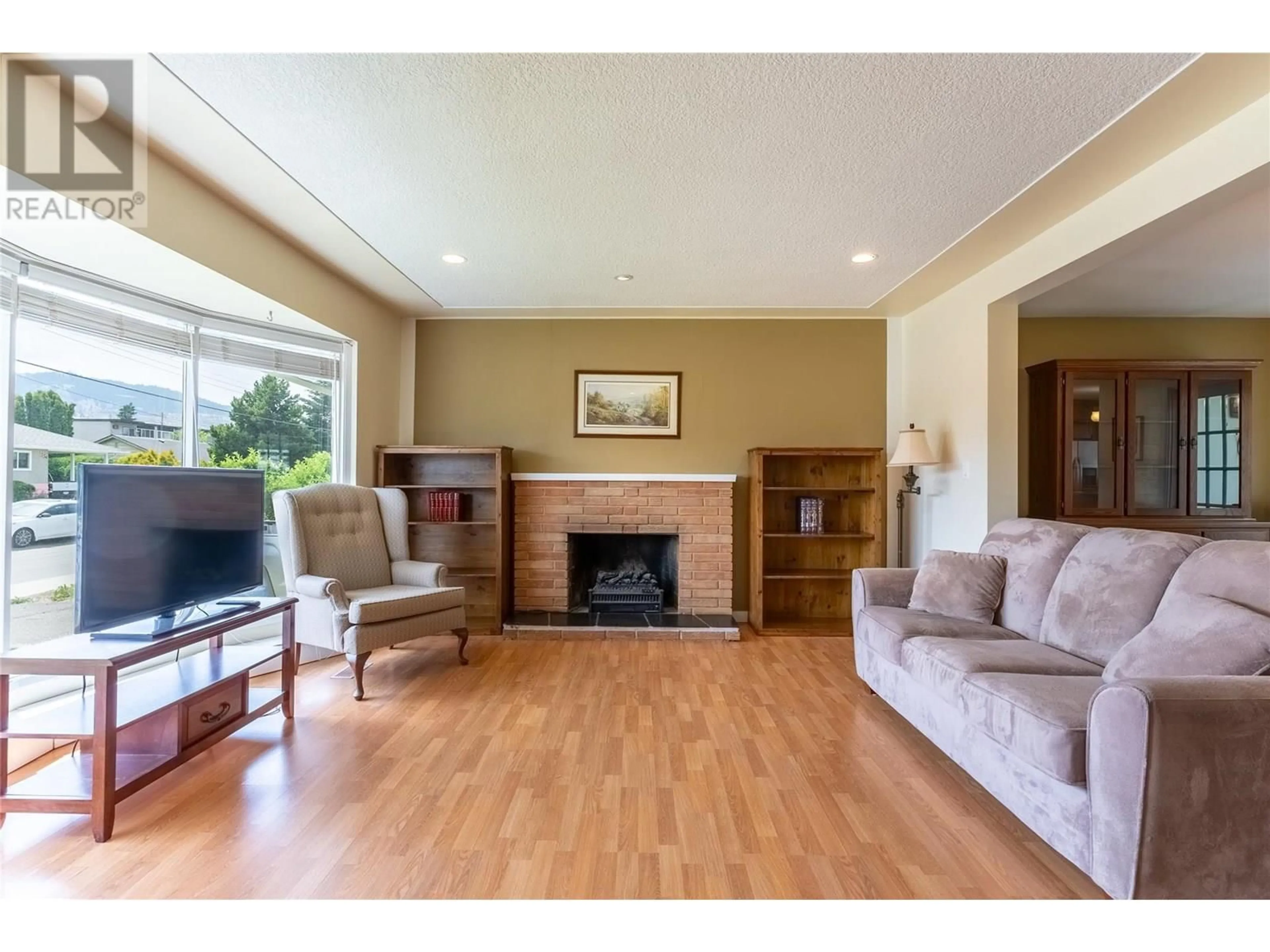 Living room with furniture, wood/laminate floor for 249 CHESTNUT AVENUE, Kamloops British Columbia V2B1L4