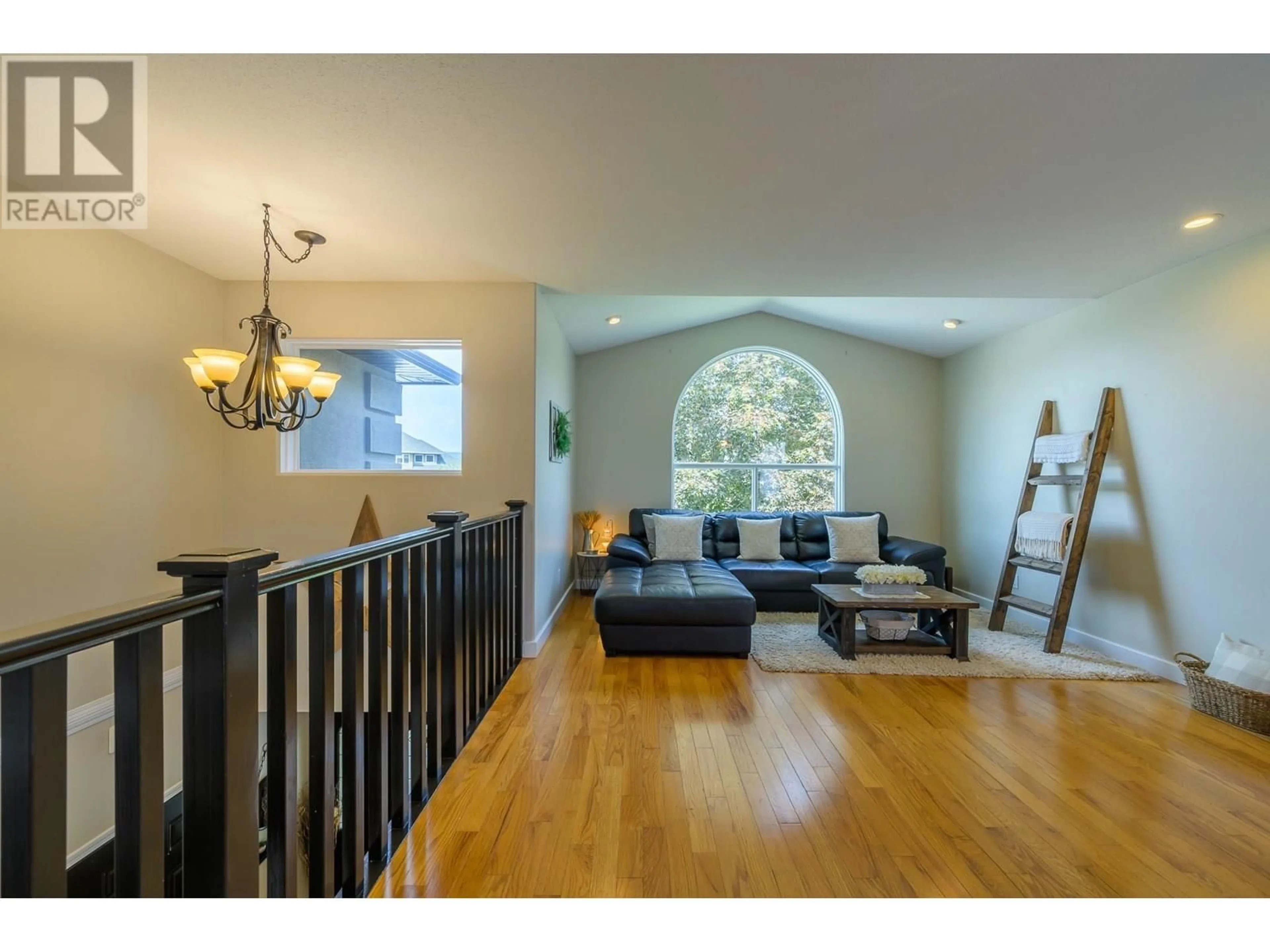Living room with furniture, wood/laminate floor for 682 SANDSTONE PLACE, Kamloops British Columbia V2B8M4