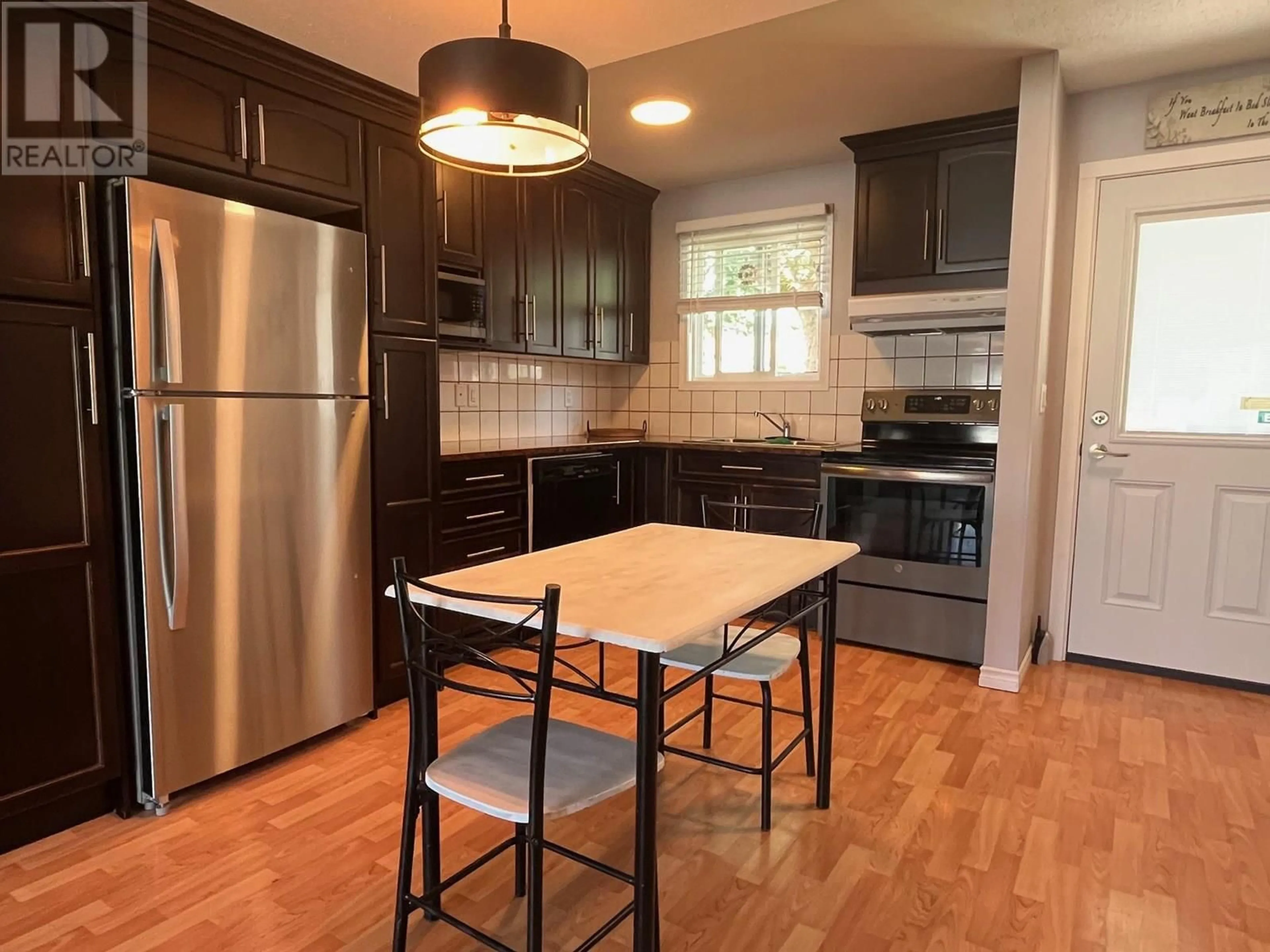 Open concept kitchen, wood/laminate floor for 48 - 2250 BASKIN STREET, Penticton British Columbia V2A8M5