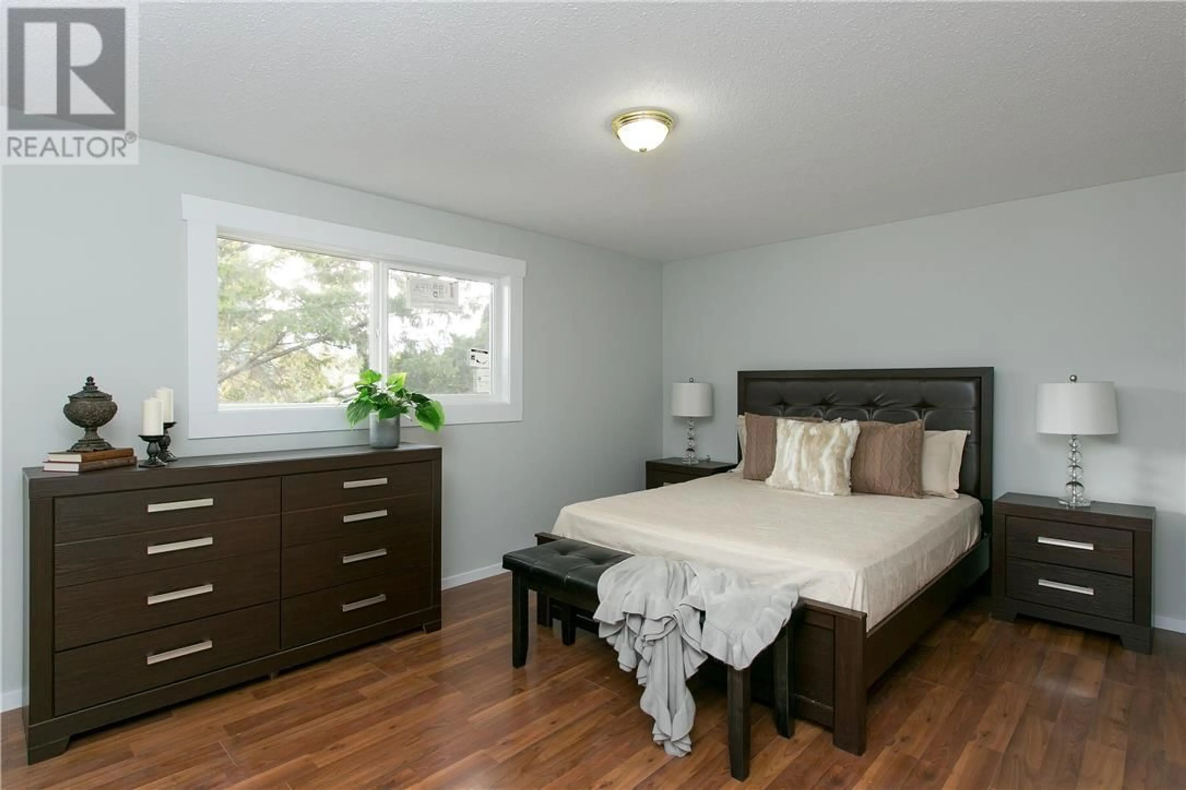 Bedroom with bed, wood/laminate floor for 130 DYSART ROAD, Kelowna British Columbia V1X3R1