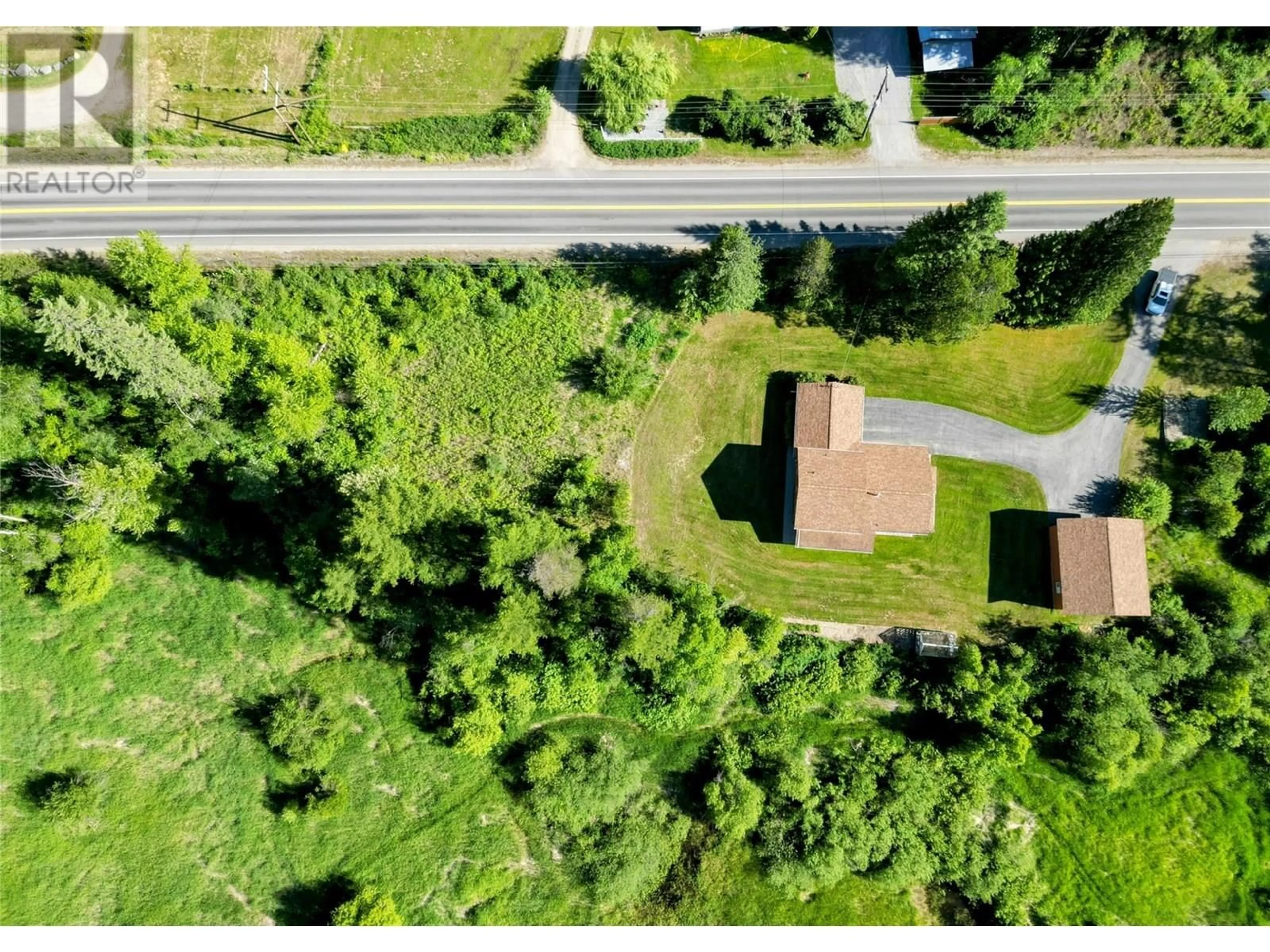 A pic from outside/outdoor area/front of a property/back of a property/a pic from drone, street for 2235 HIGHWAY 3B OTHER, Fruitvale British Columbia V0G1L0