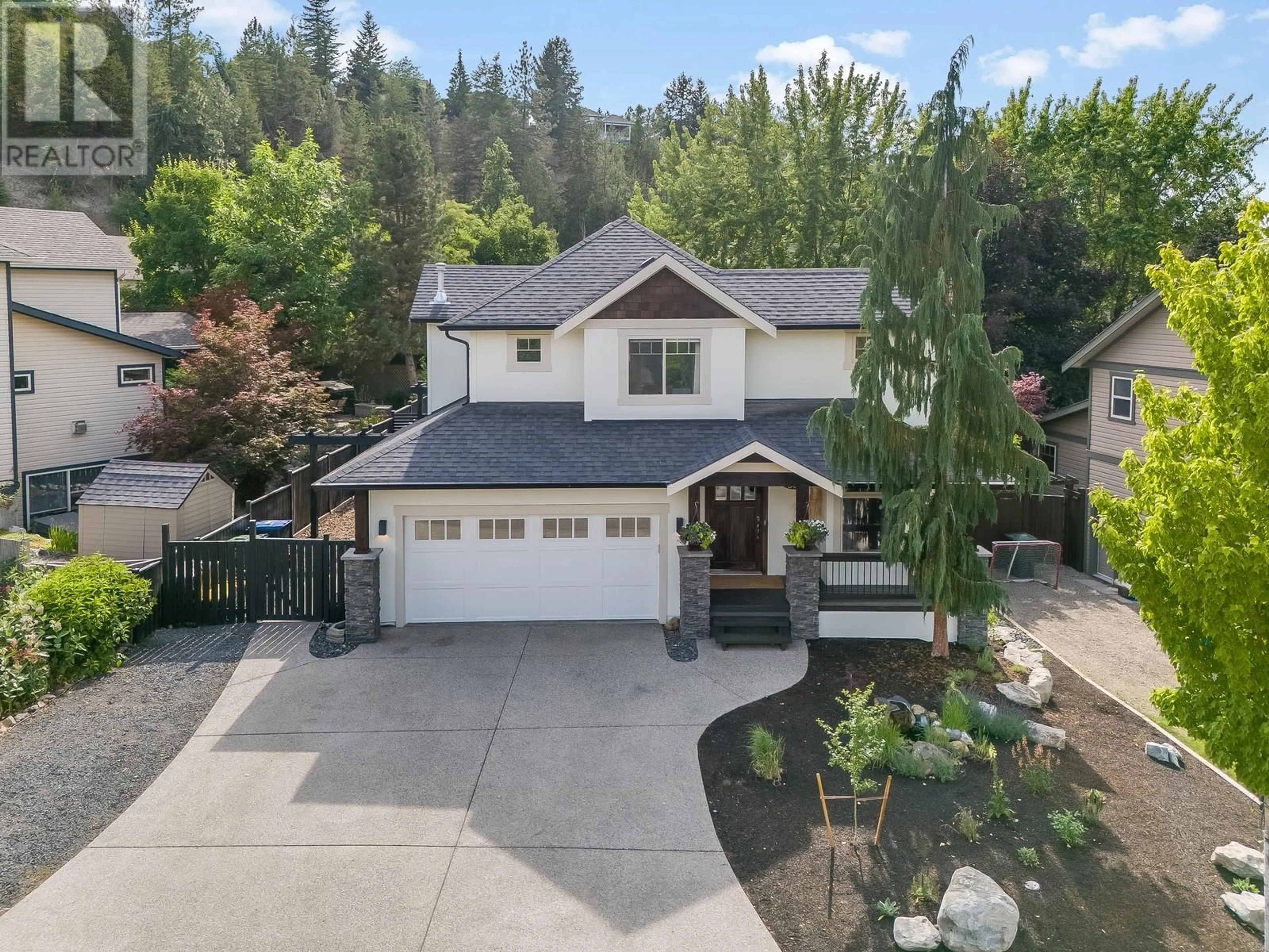 A pic from outside/outdoor area/front of a property/back of a property/a pic from drone, street for 985 PARET CRESCENT, Kelowna British Columbia V1W4X9