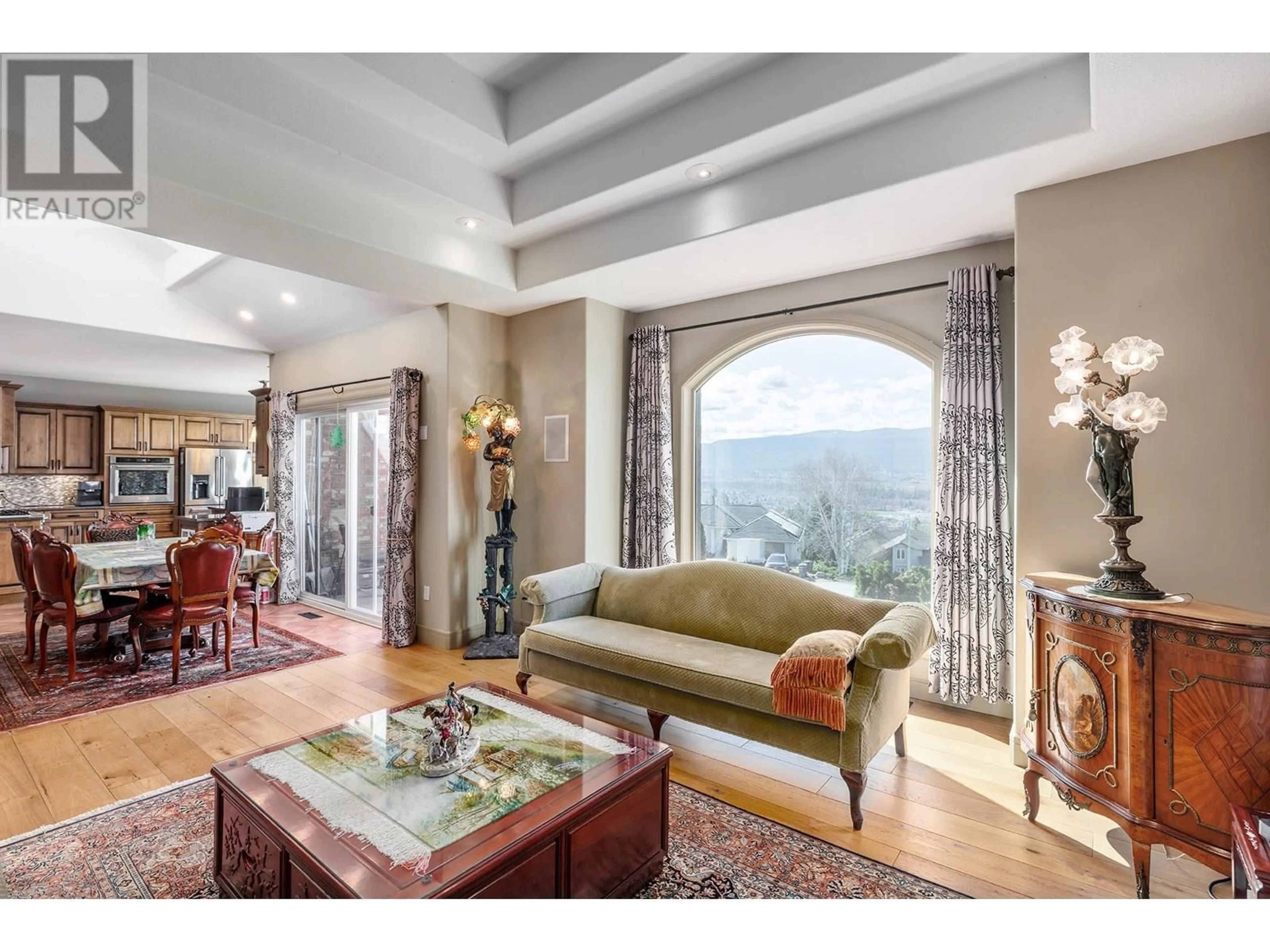 Living room with furniture, ceramic/tile floor for 2376 NAHANNI COURT, Kelowna British Columbia V1V1N1