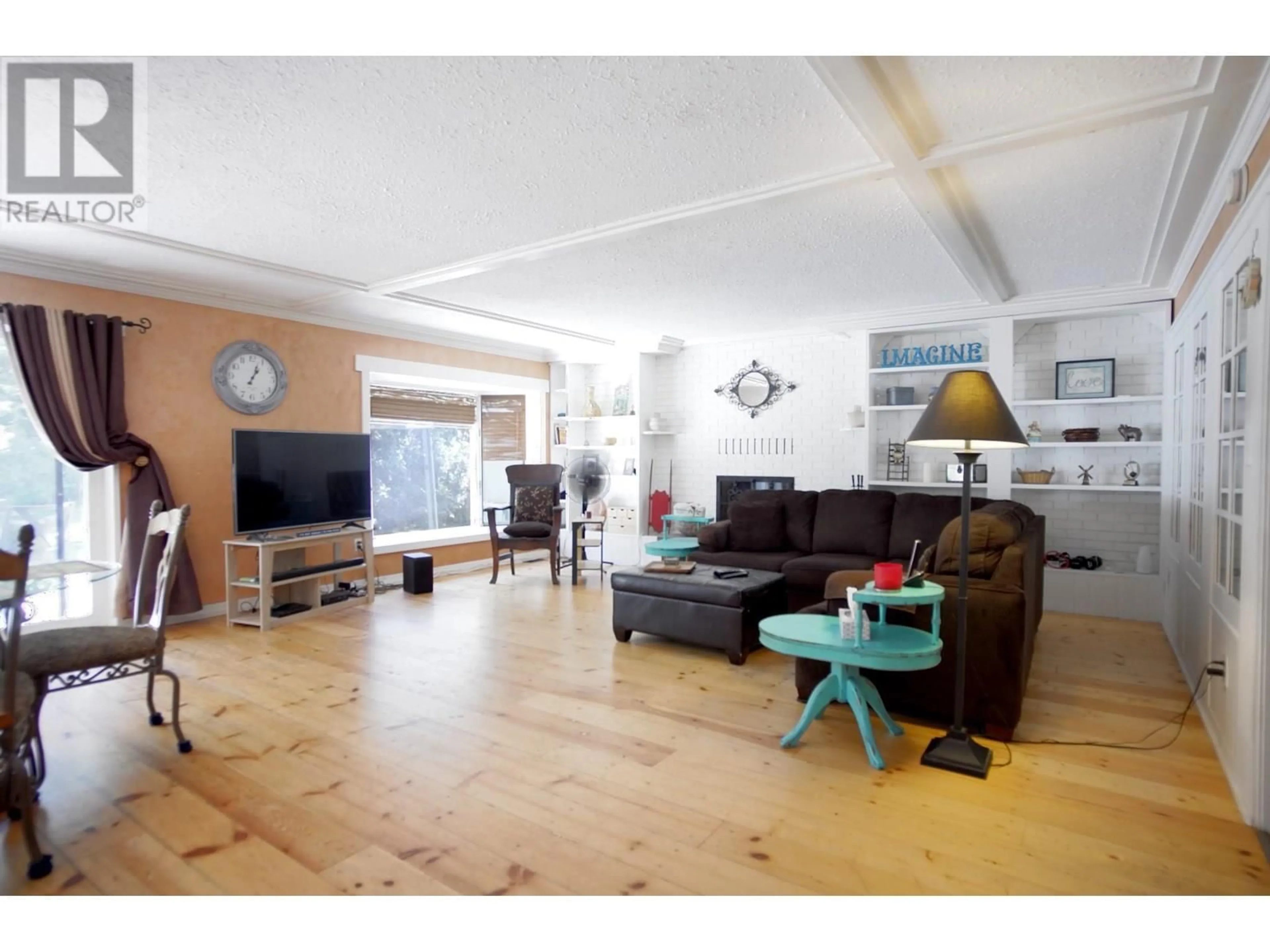 Living room with furniture, wood/laminate floor for 131 SALMON RIVER ROAD, Salmon Arm British Columbia V1E3E3