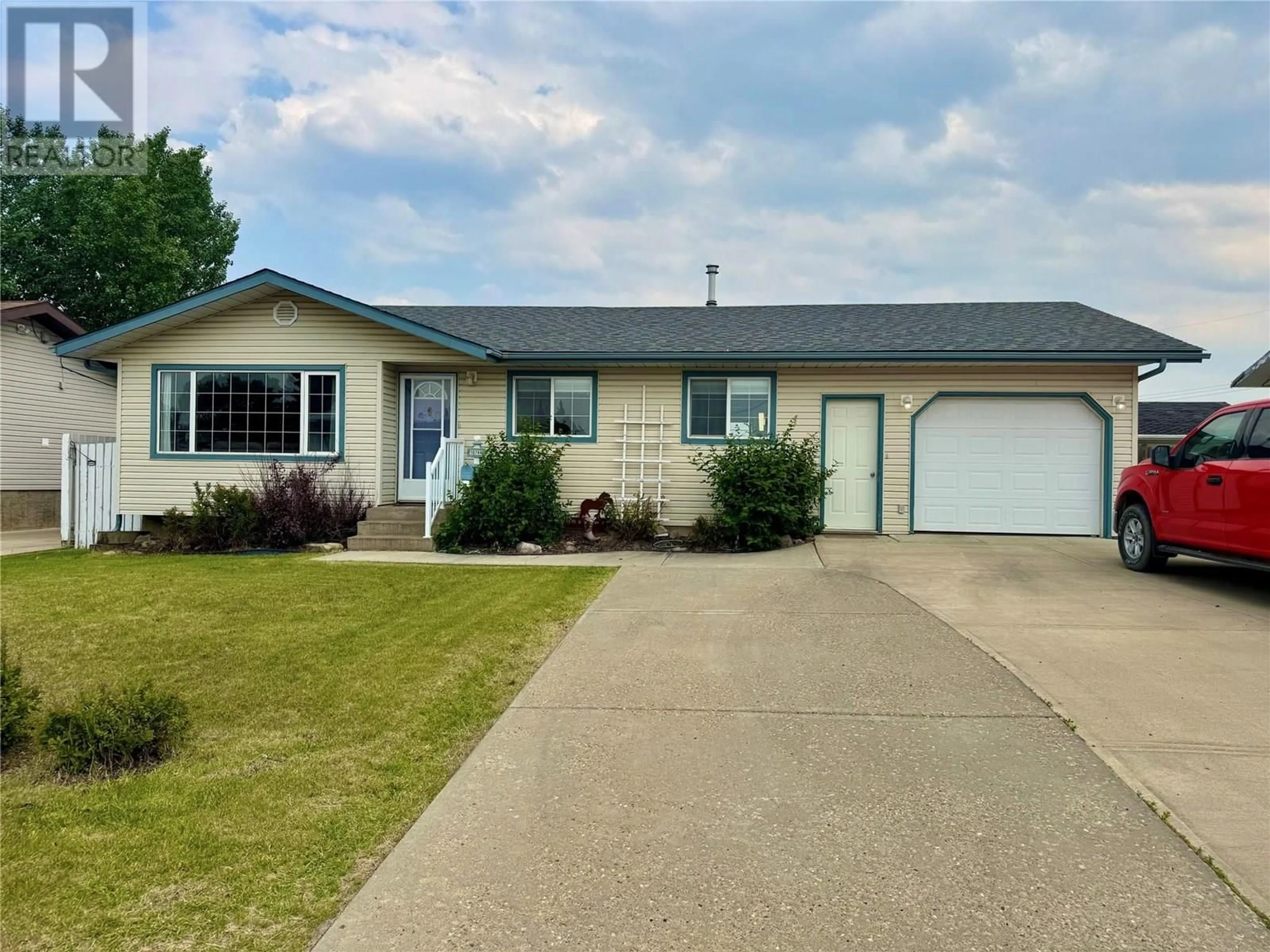 Home with vinyl exterior material, street for 10744 18 STREET, Dawson Creek British Columbia V1G4E2