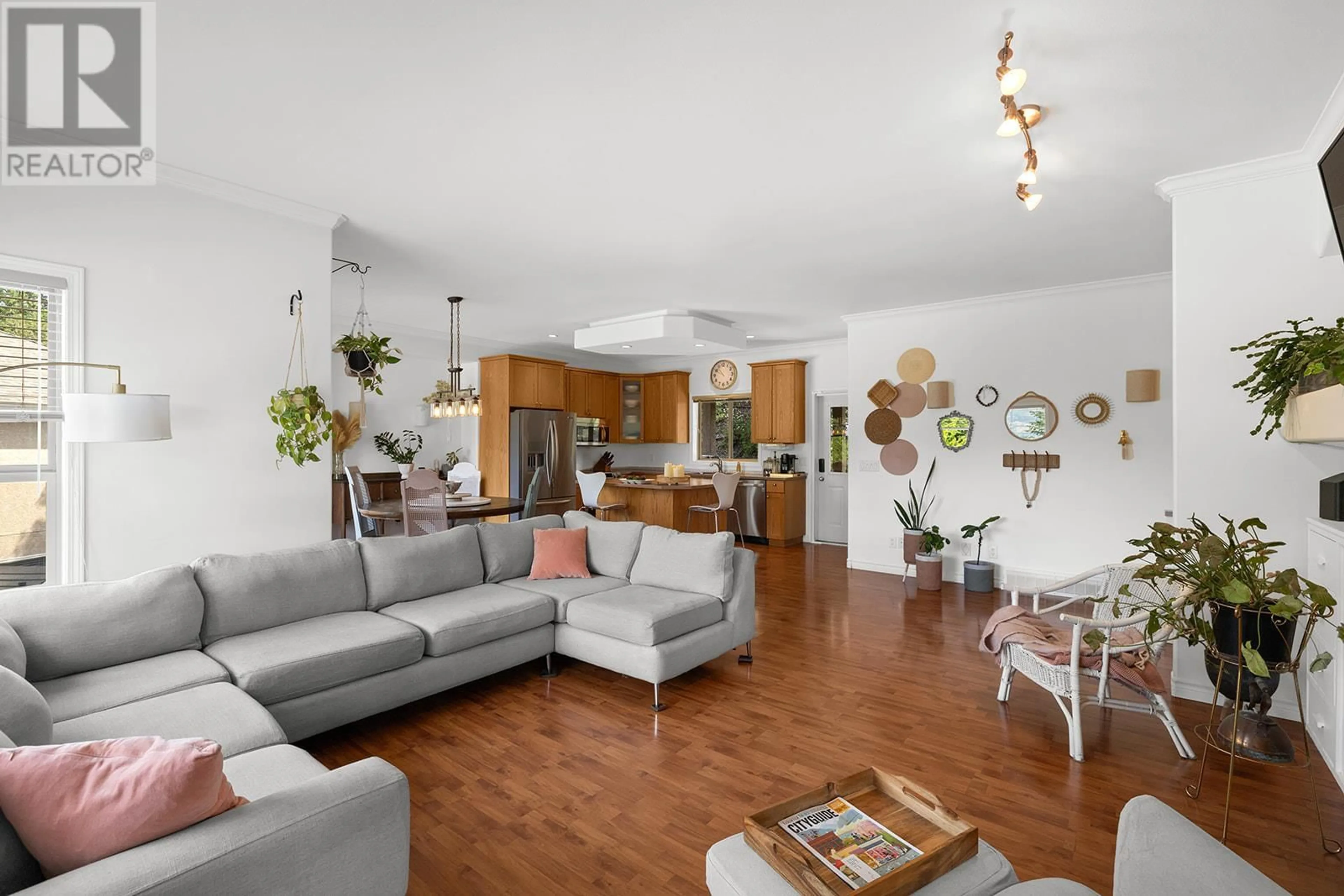 Living room with furniture, wood/laminate floor for 207 TERRACE DRIVE, Kelowna British Columbia V1V2P9