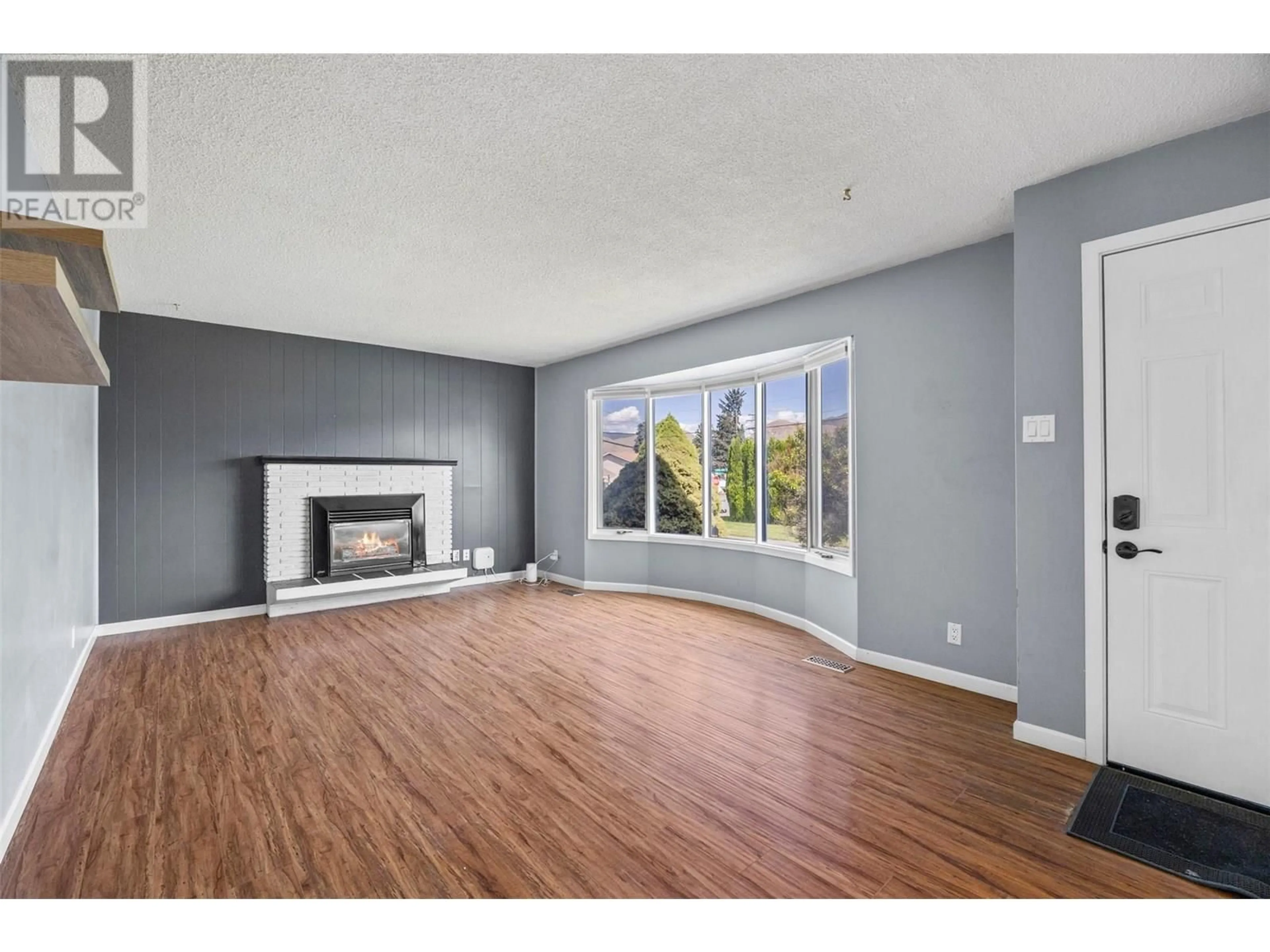 Living room with furniture, wood/laminate floor for 971 KIRKLAND PLACE, Kamloops British Columbia V2B3Y7