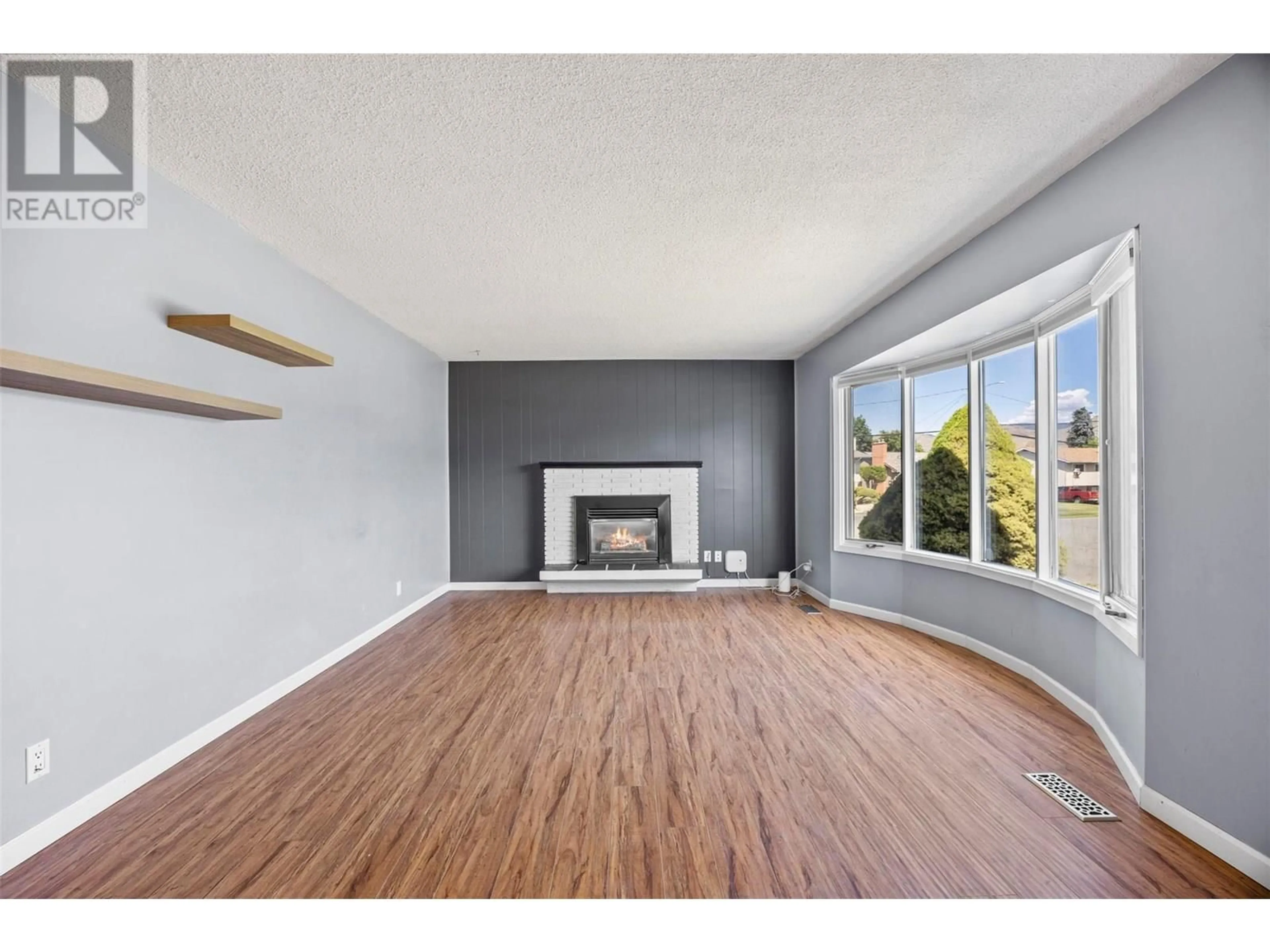 Living room with furniture, wood/laminate floor for 971 KIRKLAND PLACE, Kamloops British Columbia V2B3Y7