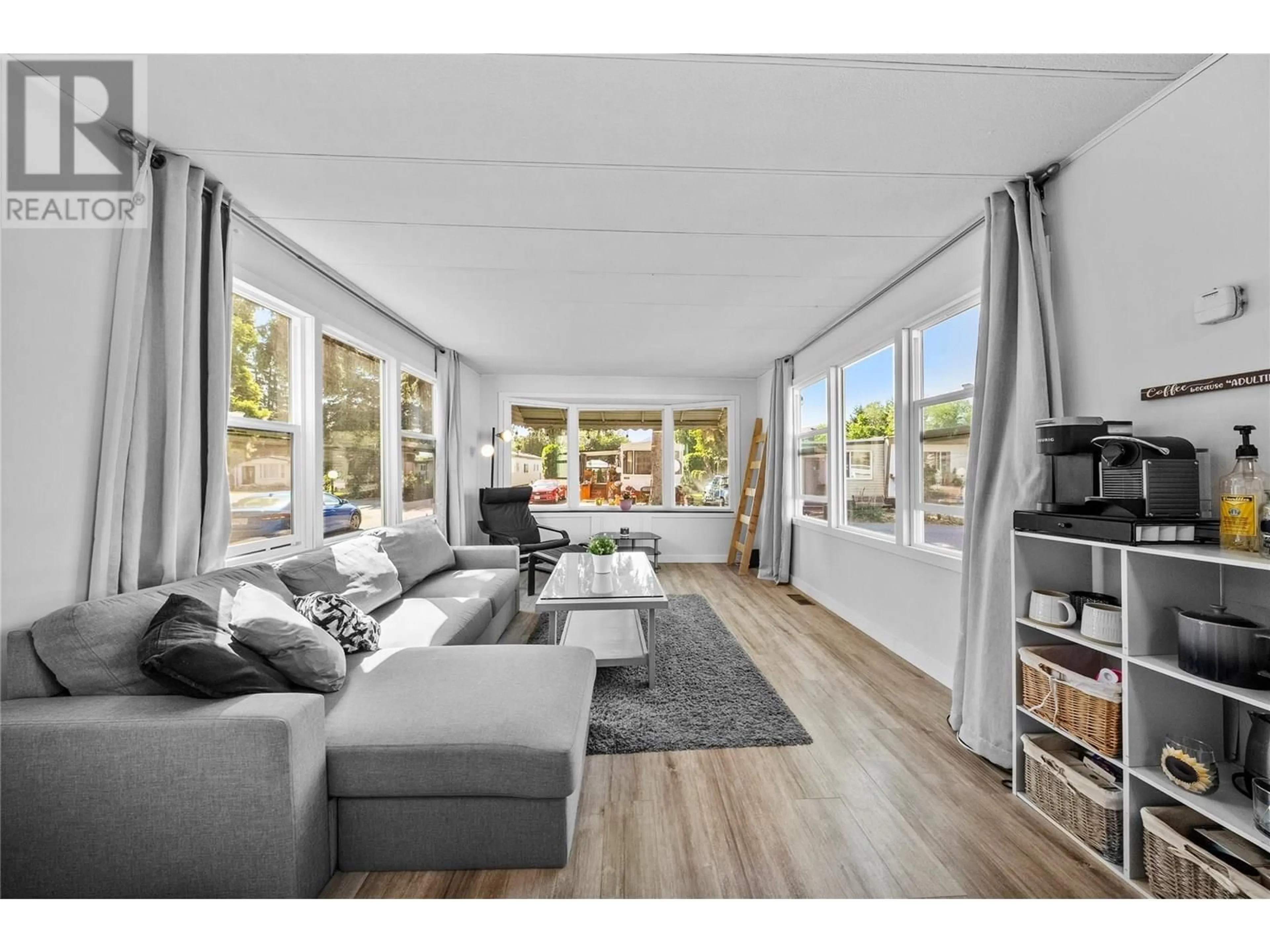Living room with furniture, wood/laminate floor for 107 - 2401 ORD ROAD, Kamloops British Columbia V2B7V8