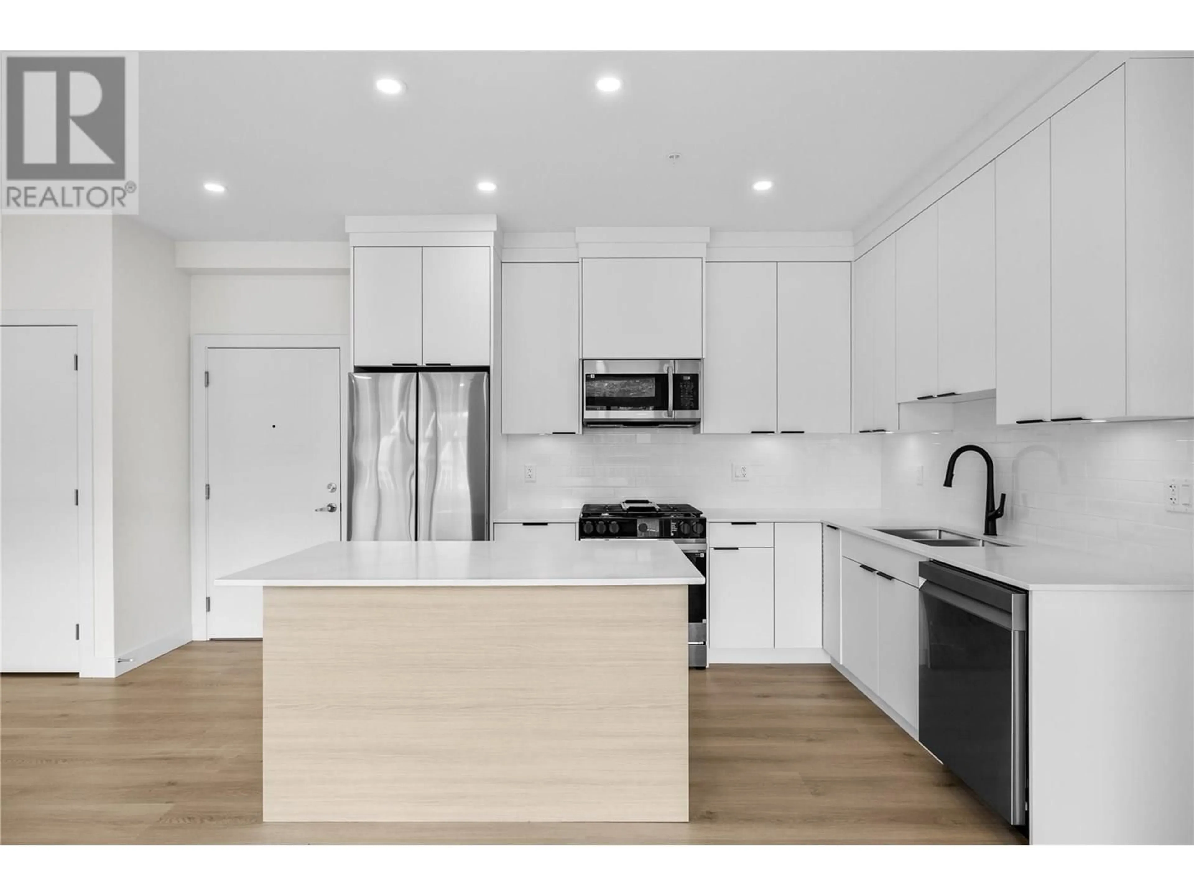 Open concept kitchen, wood/laminate floor for 202 - 5300 MAIN STREET, Kelowna British Columbia V1W0C1