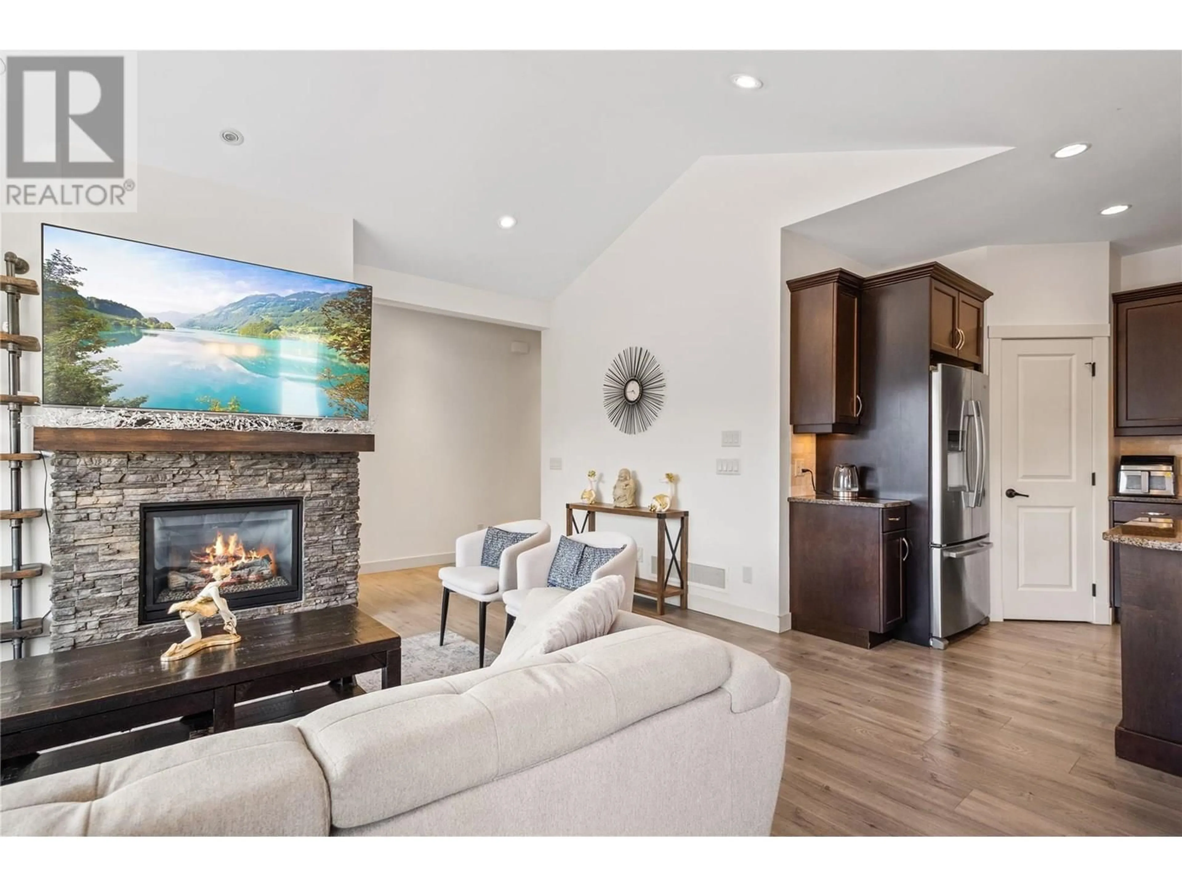 Living room with furniture, wood/laminate floor for 1338 ROCKY POINT DRIVE, Kelowna British Columbia V1V2Z9