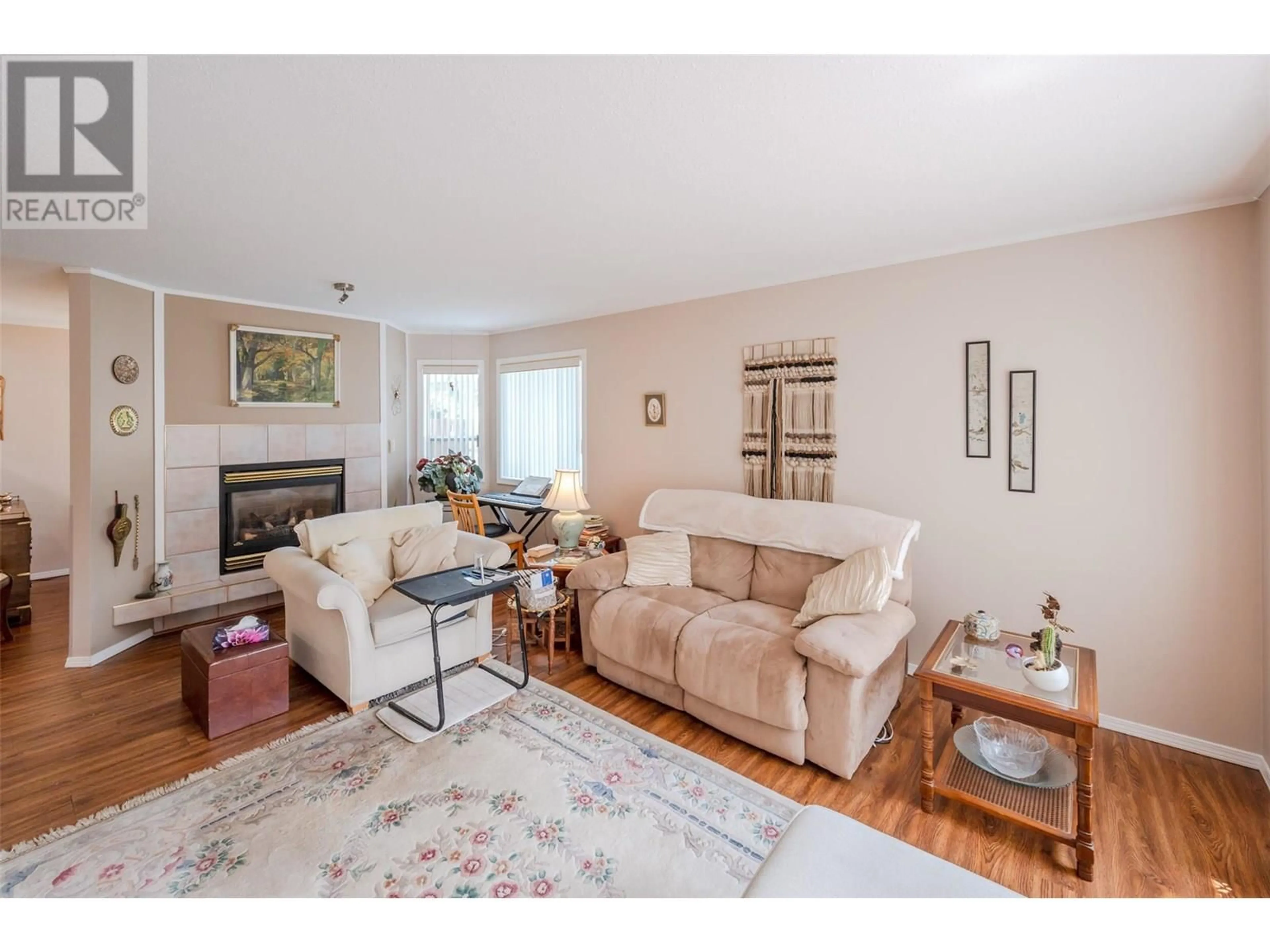 Living room with furniture, wood/laminate floor for 4 - 12606 TEMPLE COURT, Summerland British Columbia V0H1Z4
