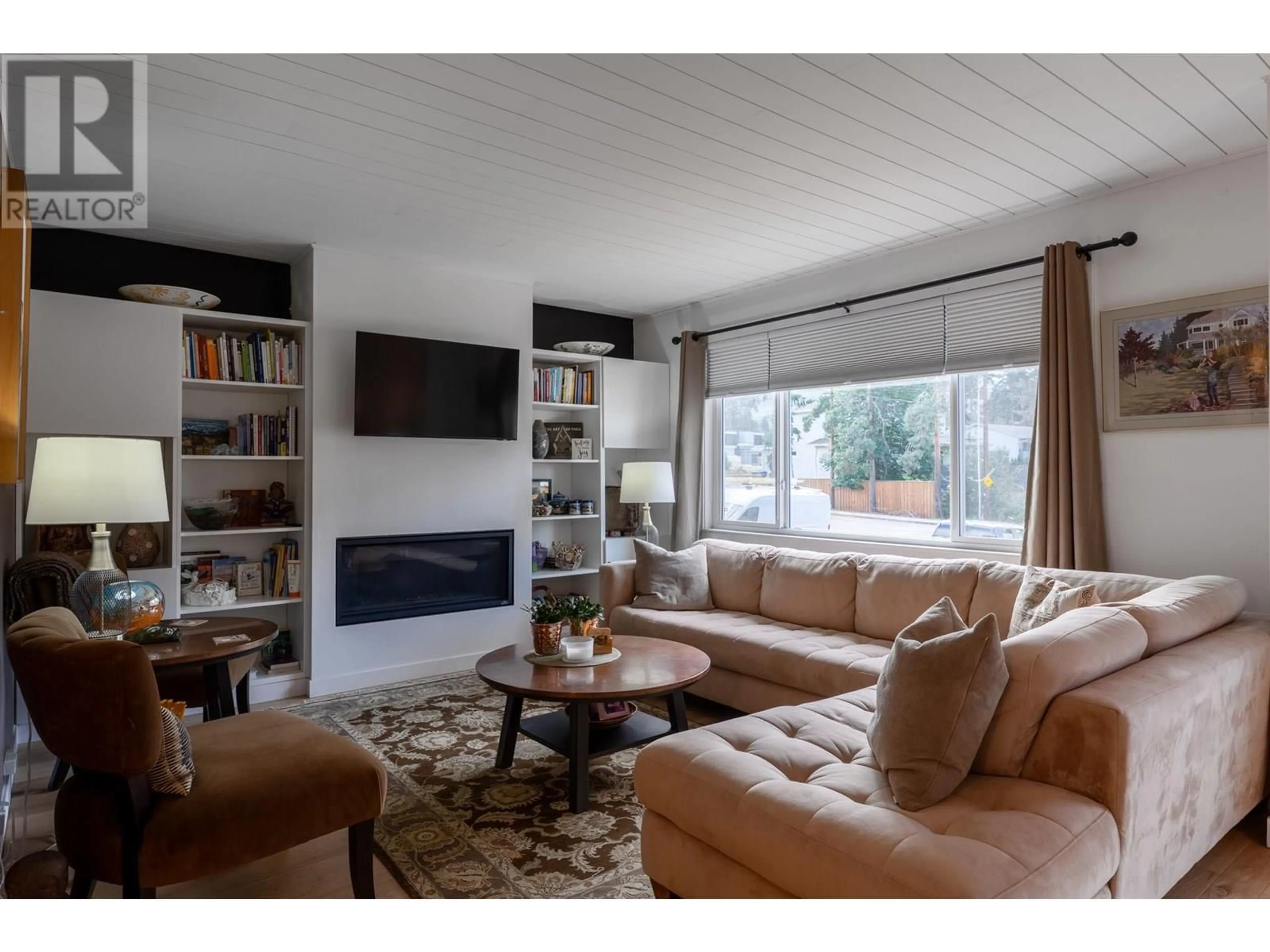 Living room with furniture, wood/laminate floor for 740 MCCLURE ROAD, Kelowna British Columbia V1W1M3