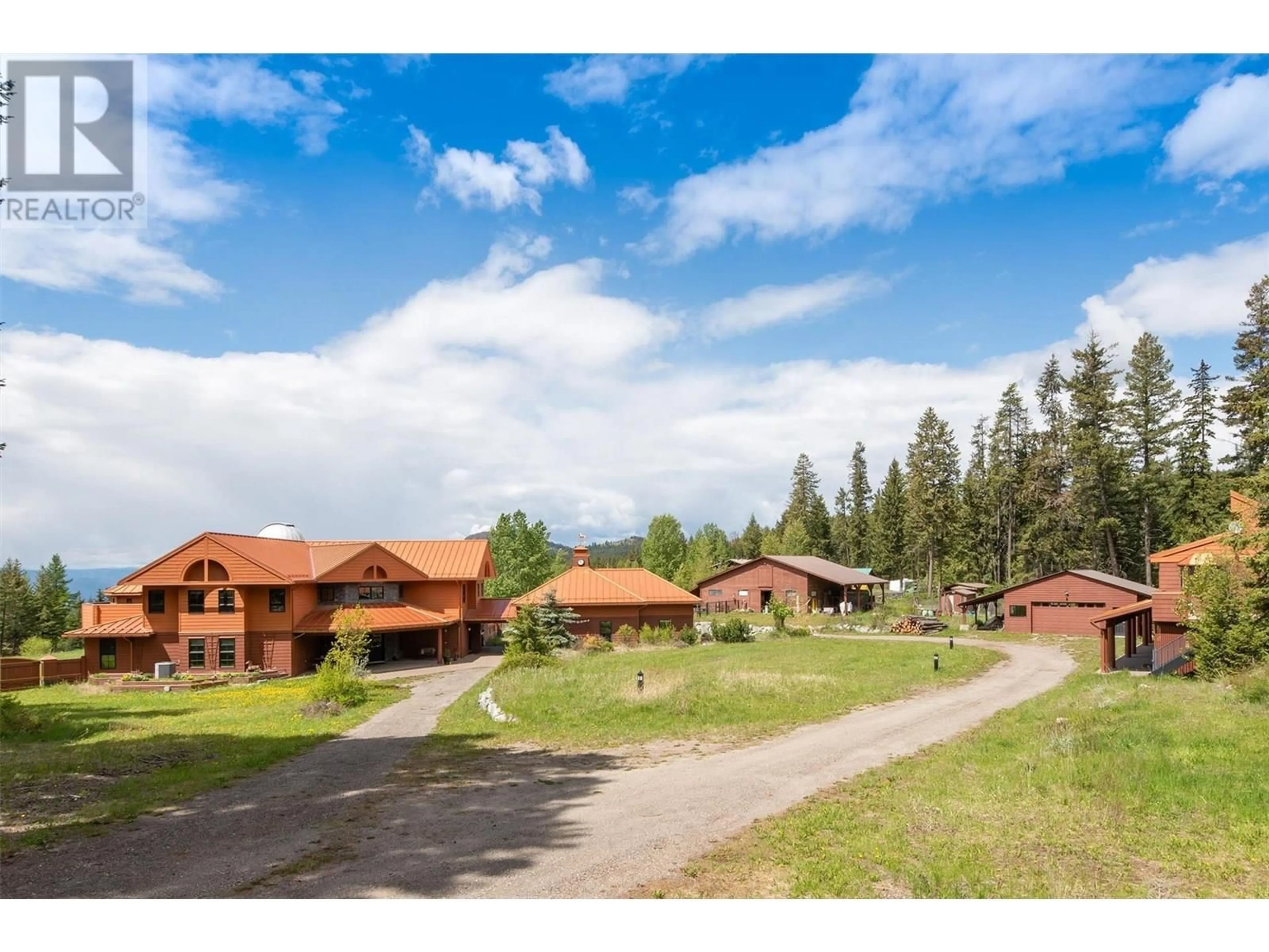 A pic from outside/outdoor area/front of a property/back of a property/a pic from drone, mountain view for 1306 HUCKLEBERRY ROAD, Kelowna British Columbia V1P1M5
