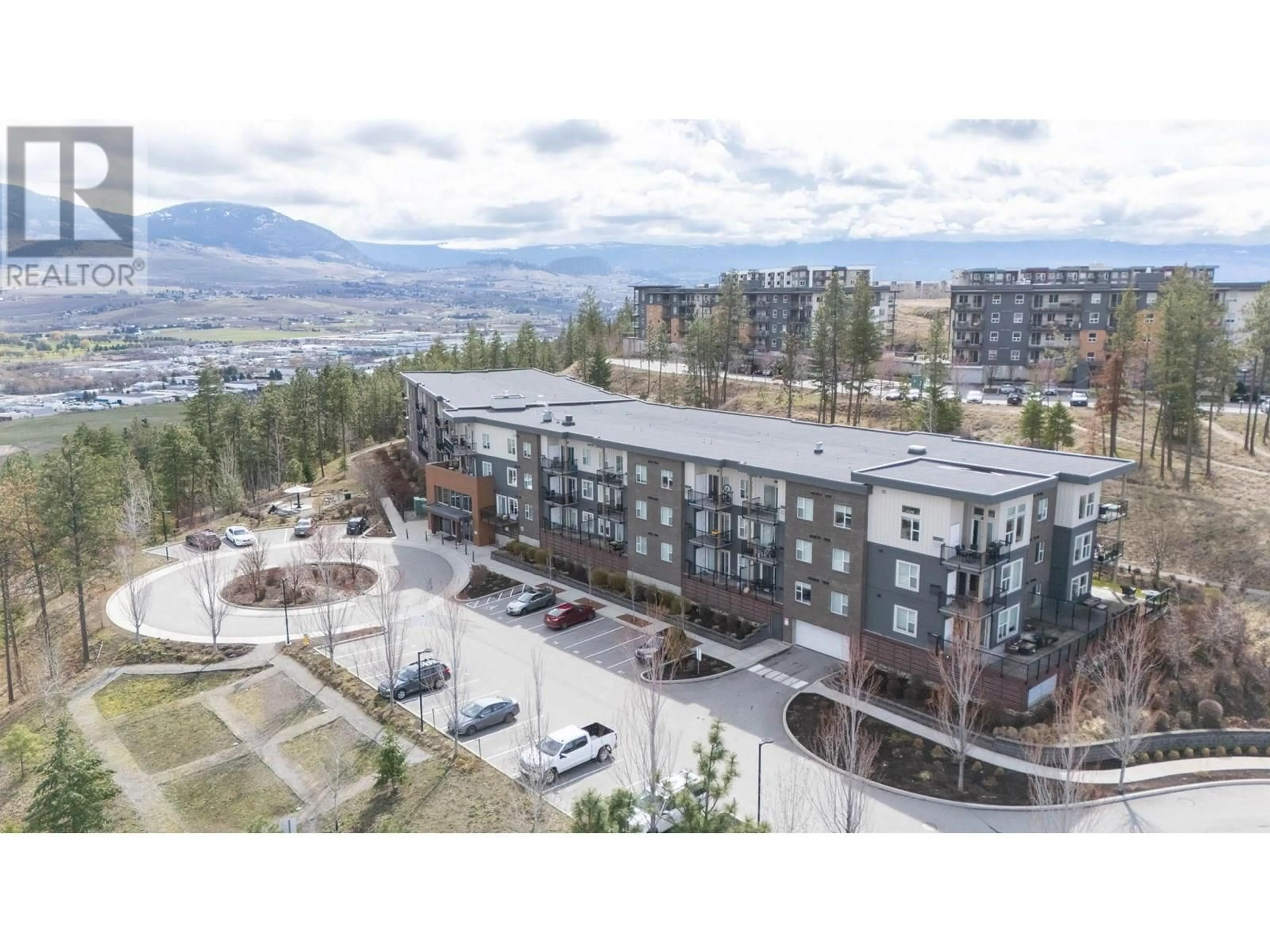 A pic from outside/outdoor area/front of a property/back of a property/a pic from drone, mountain view for 220 - 935 ACADEMY WAY, Kelowna British Columbia V1V3C9