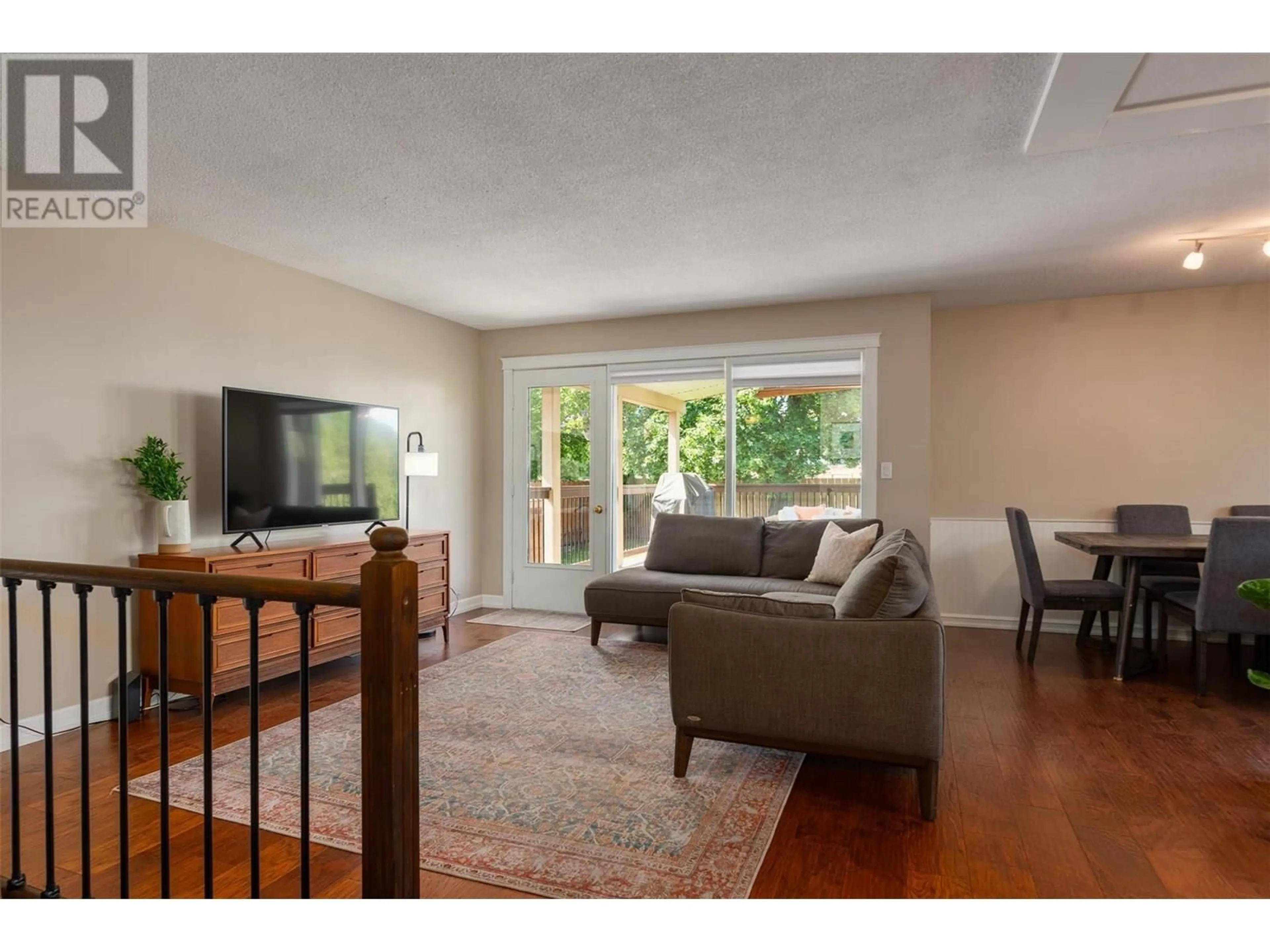 Living room with furniture, wood/laminate floor for 99 JOHNSON ROAD, Fruitvale British Columbia V0G1L0
