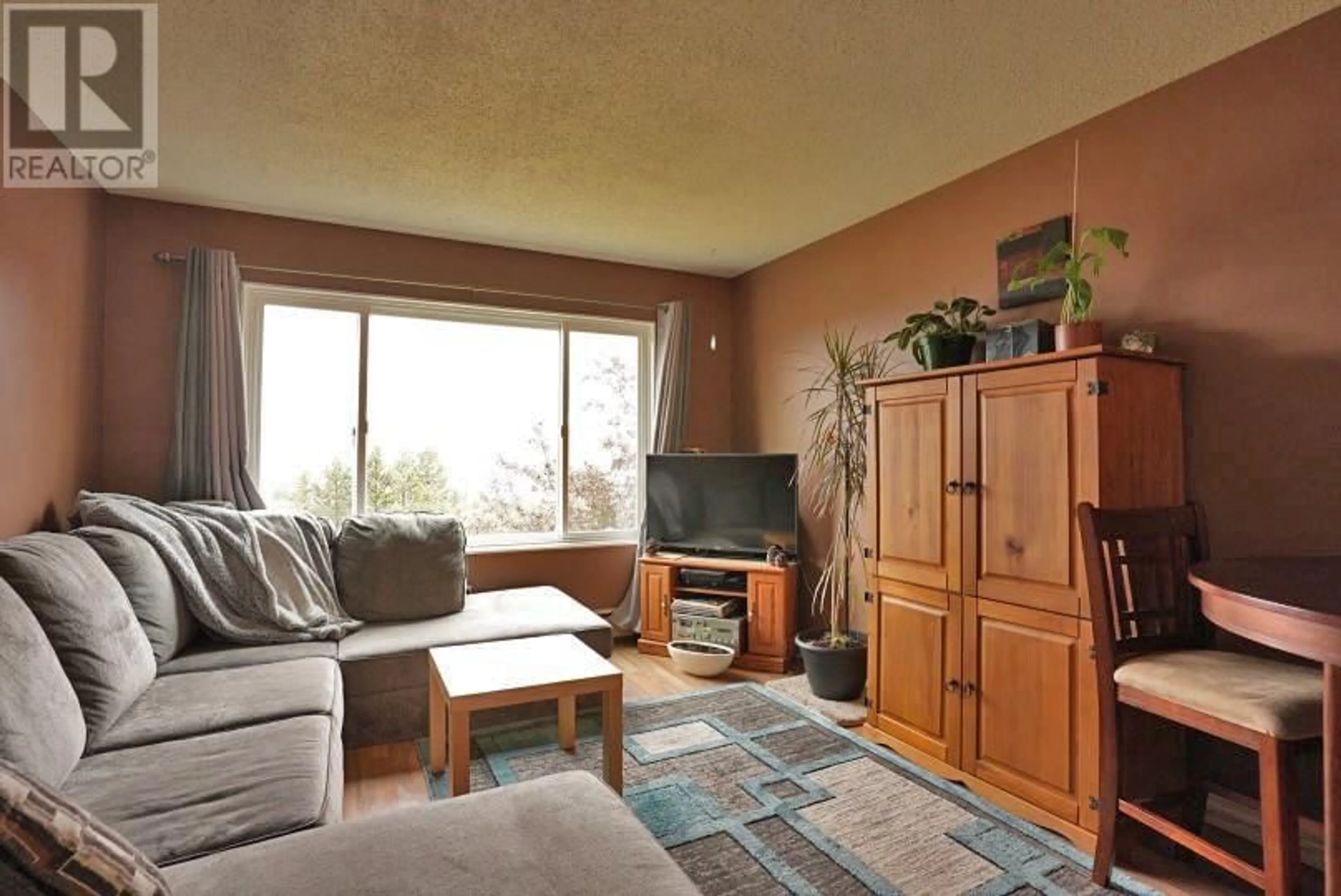 Living room with furniture, wood/laminate floor for 212 - 400 OPAL DRIVE, Logan Lake British Columbia V0K1W0