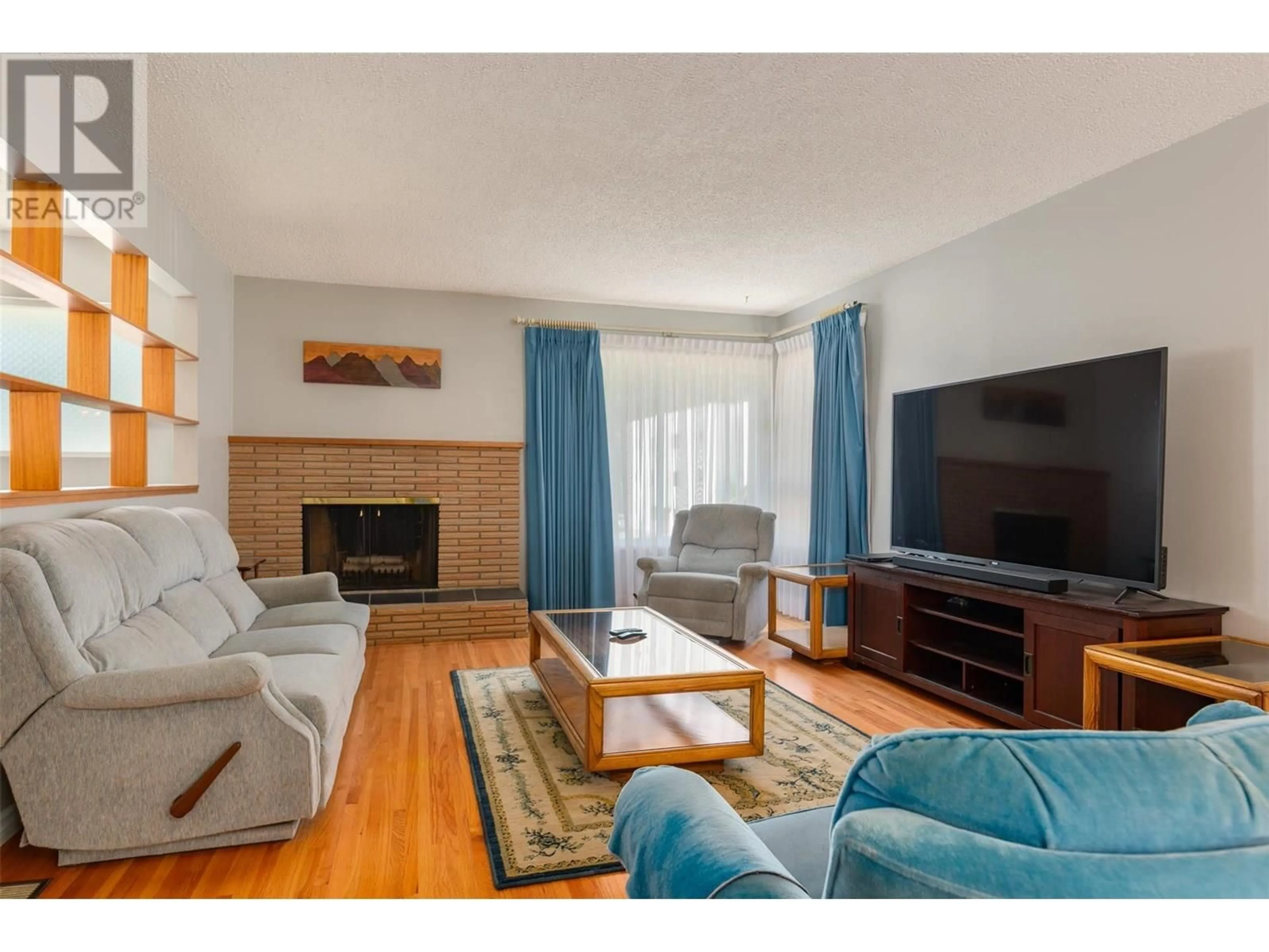 Living room with furniture, wood/laminate floor for 3555 HIGHWAY DRIVE, Trail British Columbia V1R2T9