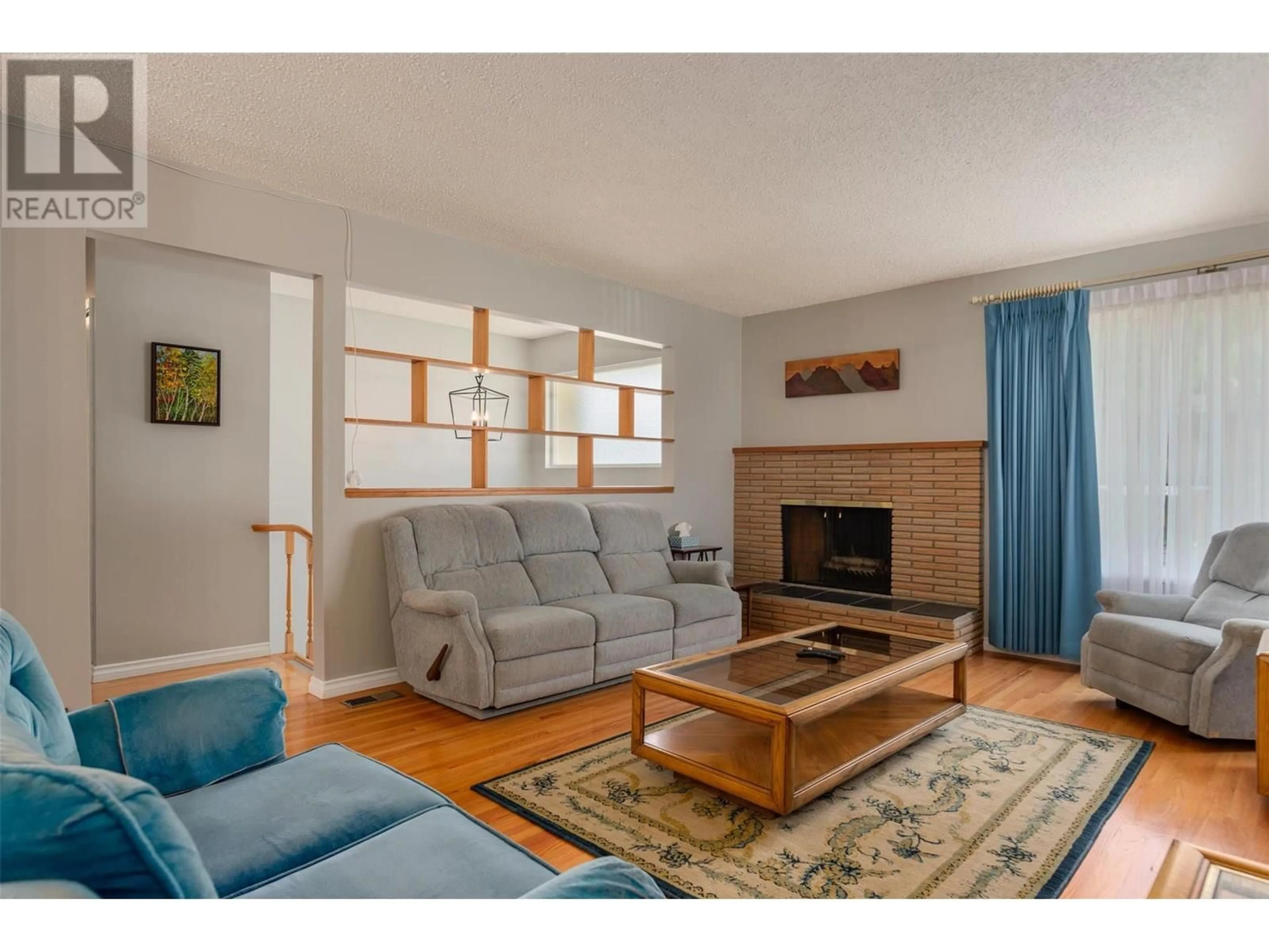 Living room with furniture, wood/laminate floor for 3555 HIGHWAY DRIVE, Trail British Columbia V1R2T9