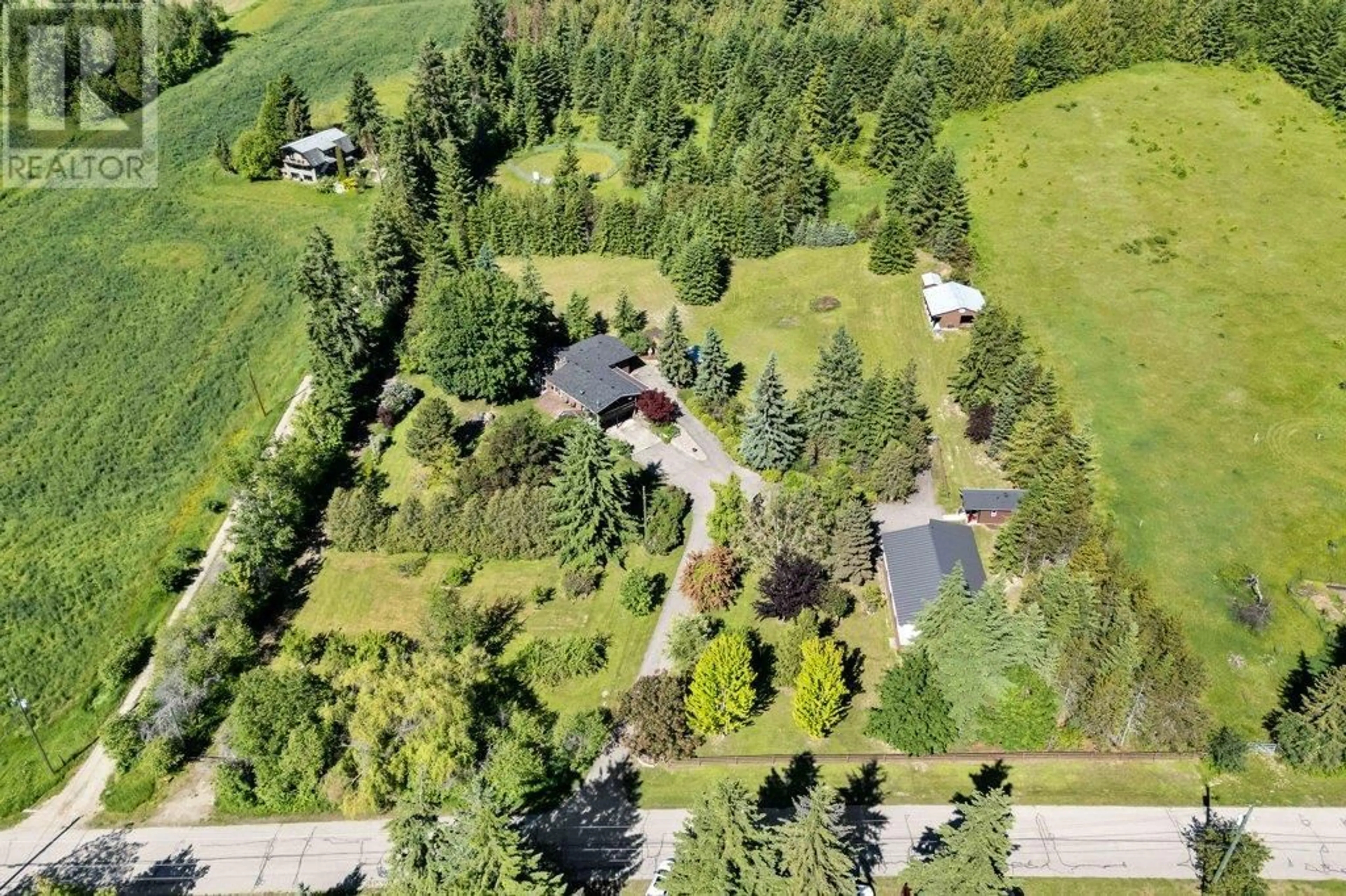 A pic from outside/outdoor area/front of a property/back of a property/a pic from drone, forest/trees view for 3681 40 STREET NORTHEAST, Salmon Arm British Columbia V1E1Z6