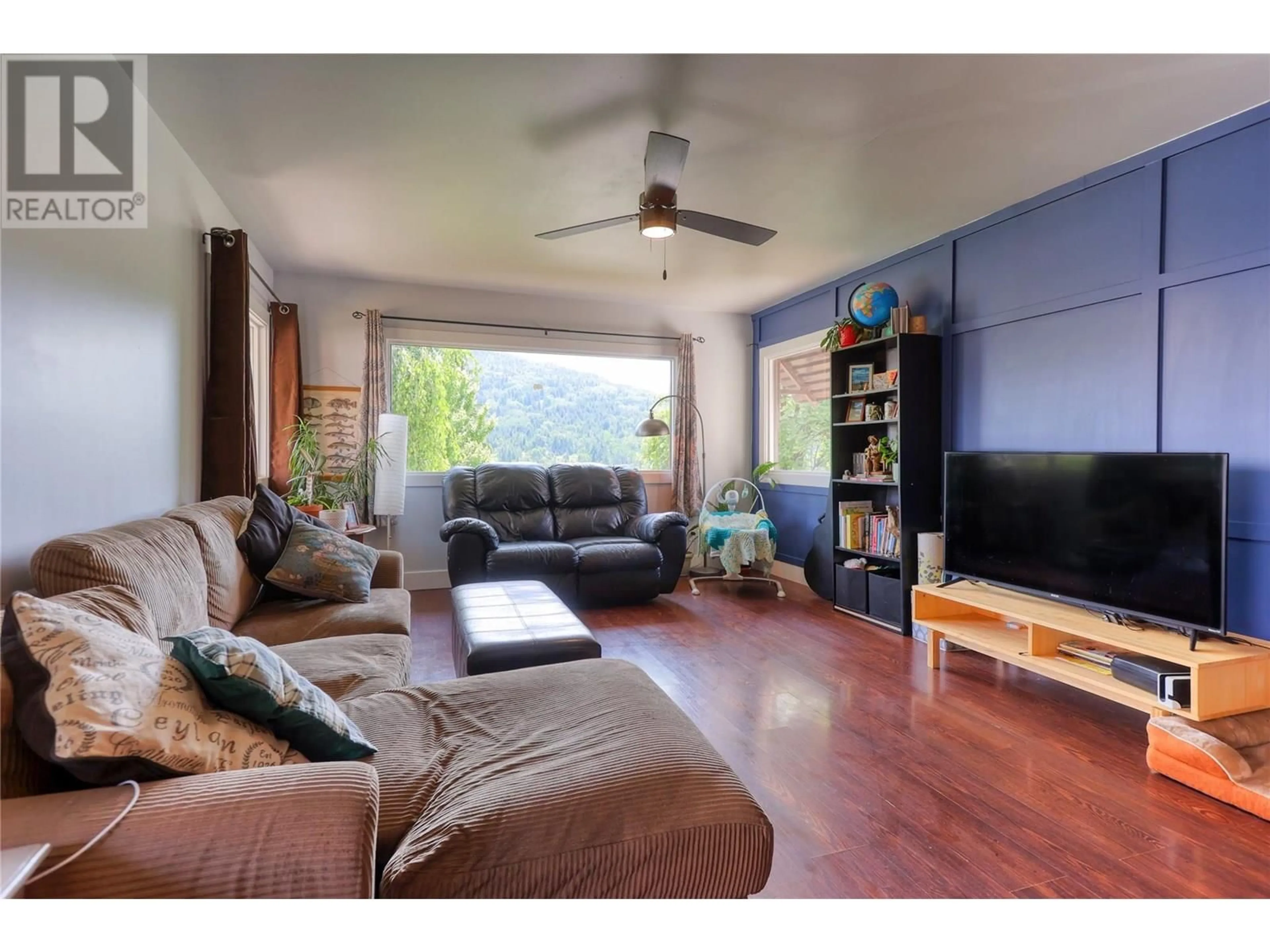 Living room with furniture, wood/laminate floor for 775 DICKENS STREET, Warfield British Columbia V1R2B7